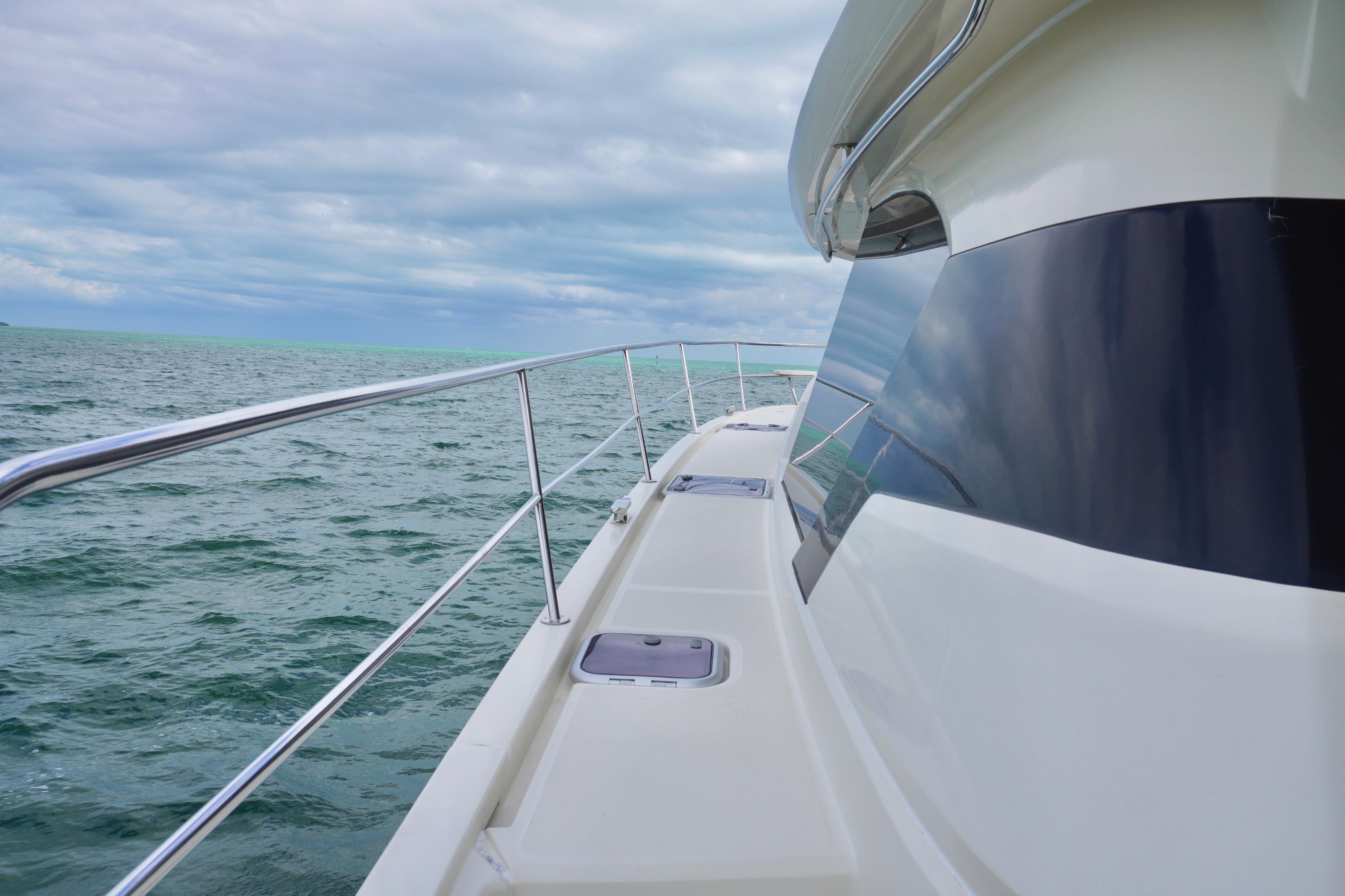 Side view of 2017 Aquila 44 Yacht on open sea under cloudy sky.