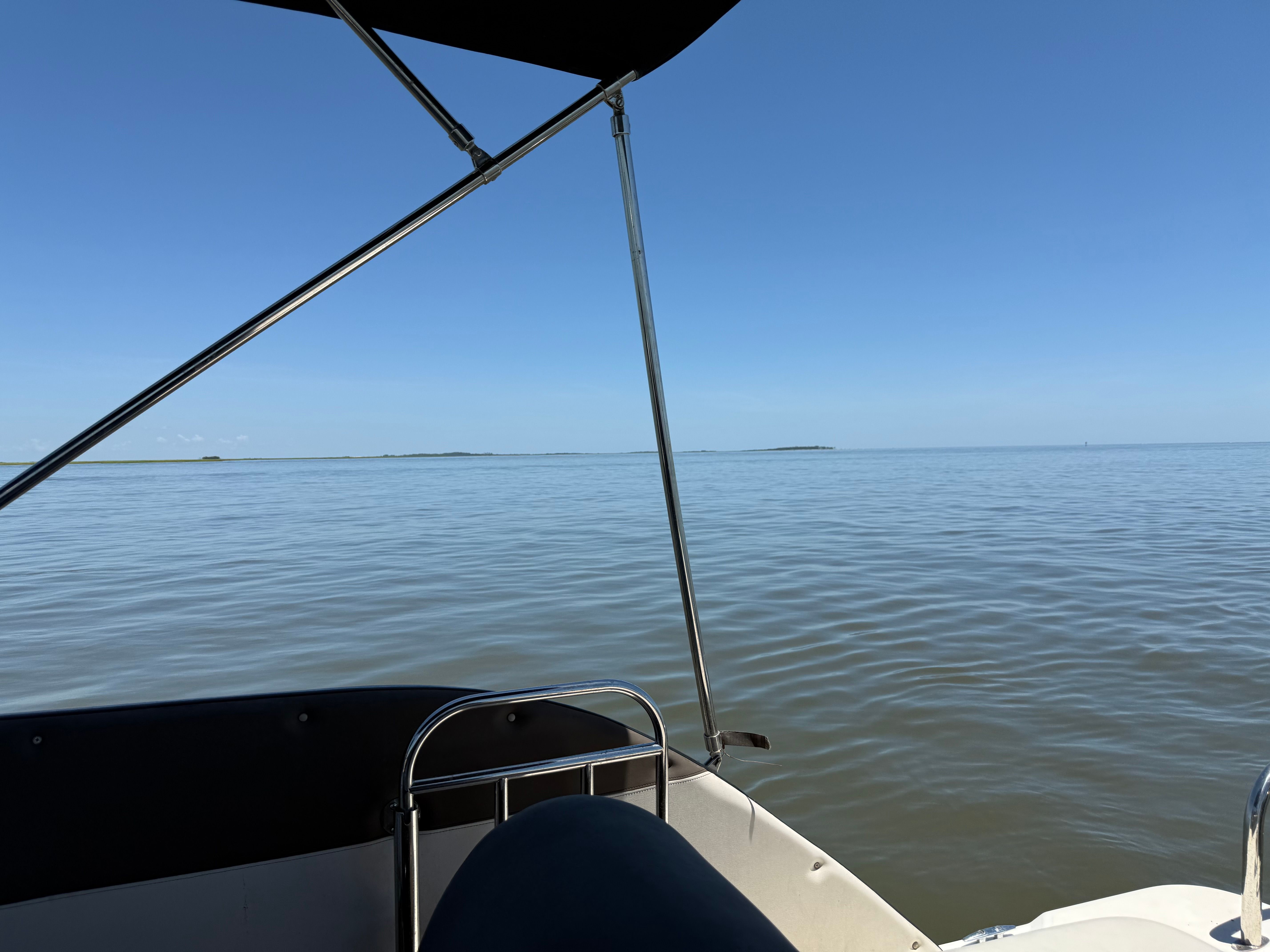 View from a Bayliner Element XR7 boat on calm water under a clear sky.
