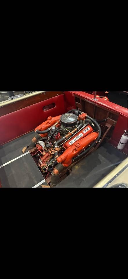 1965 Century Sabre boat engine in red interior.
