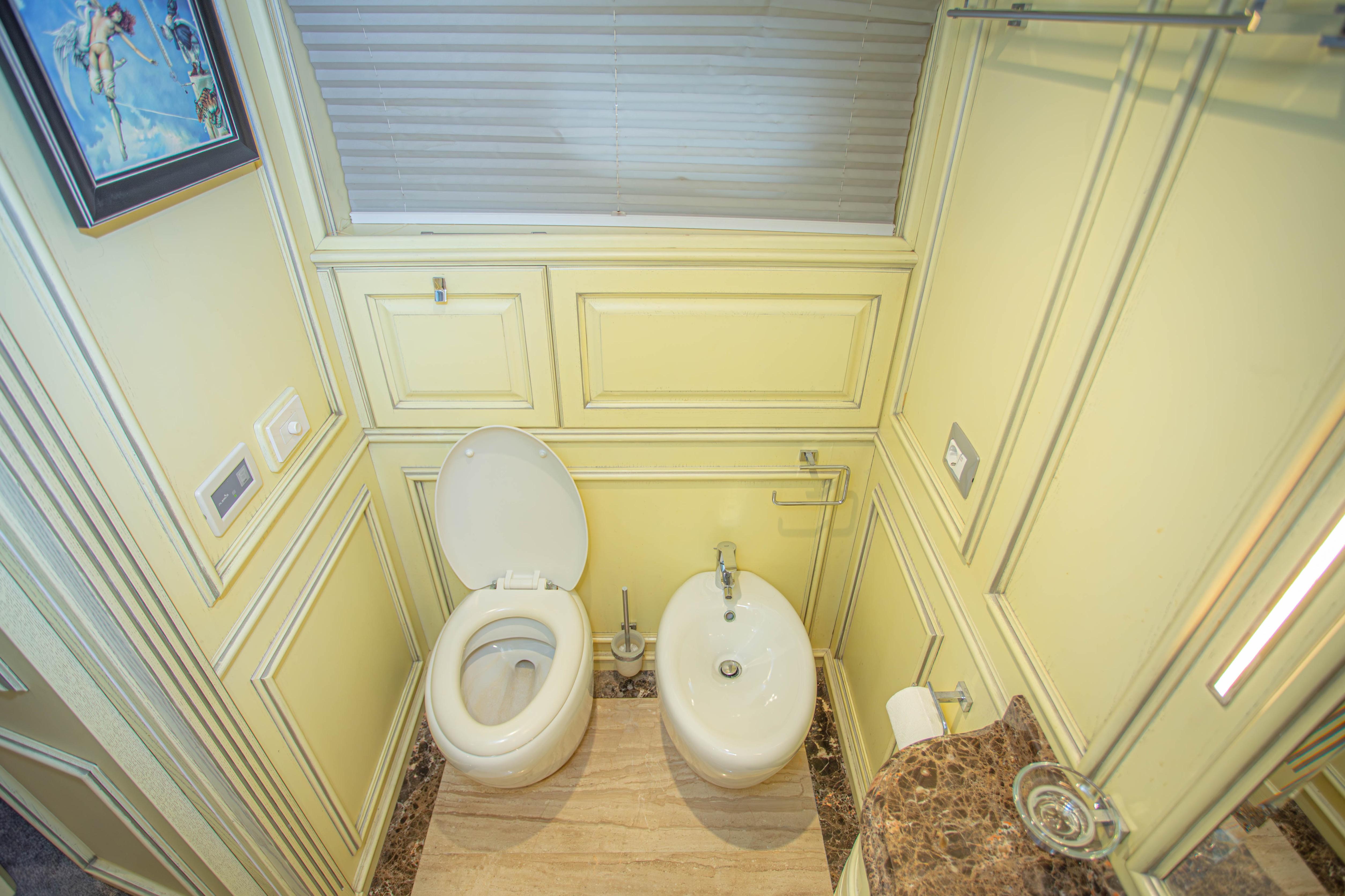 Luxurious bathroom on 2014 Fifth Ocean Yachts 24m Explorer Yacht, featuring toilet and bidet.