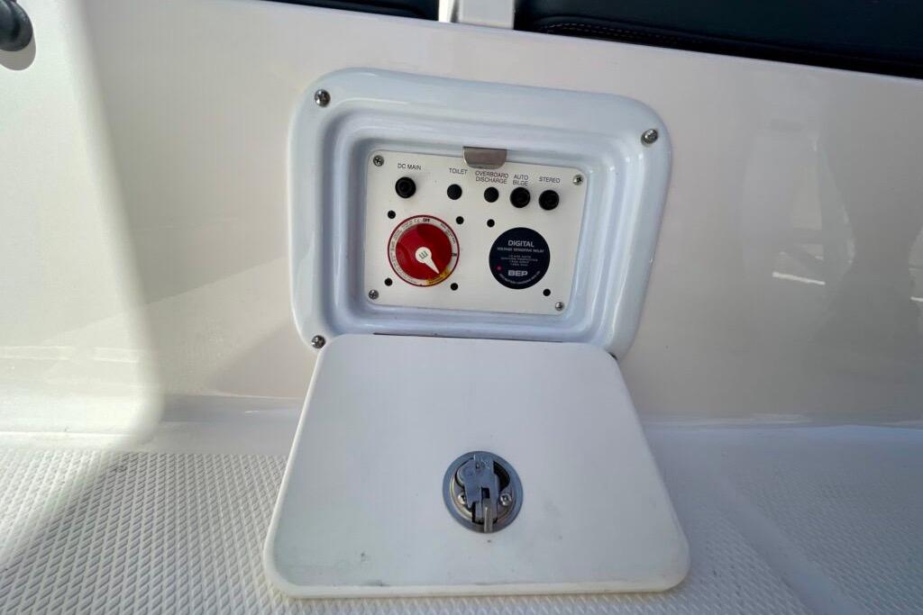Control panel on 2022 Robalo R230 Center Console boat, featuring switches and digital display.