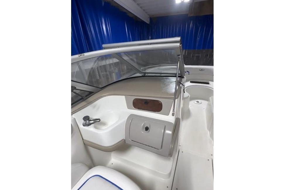 1999 Tide Craft Trophy Angler boat interior with steering console and seating.