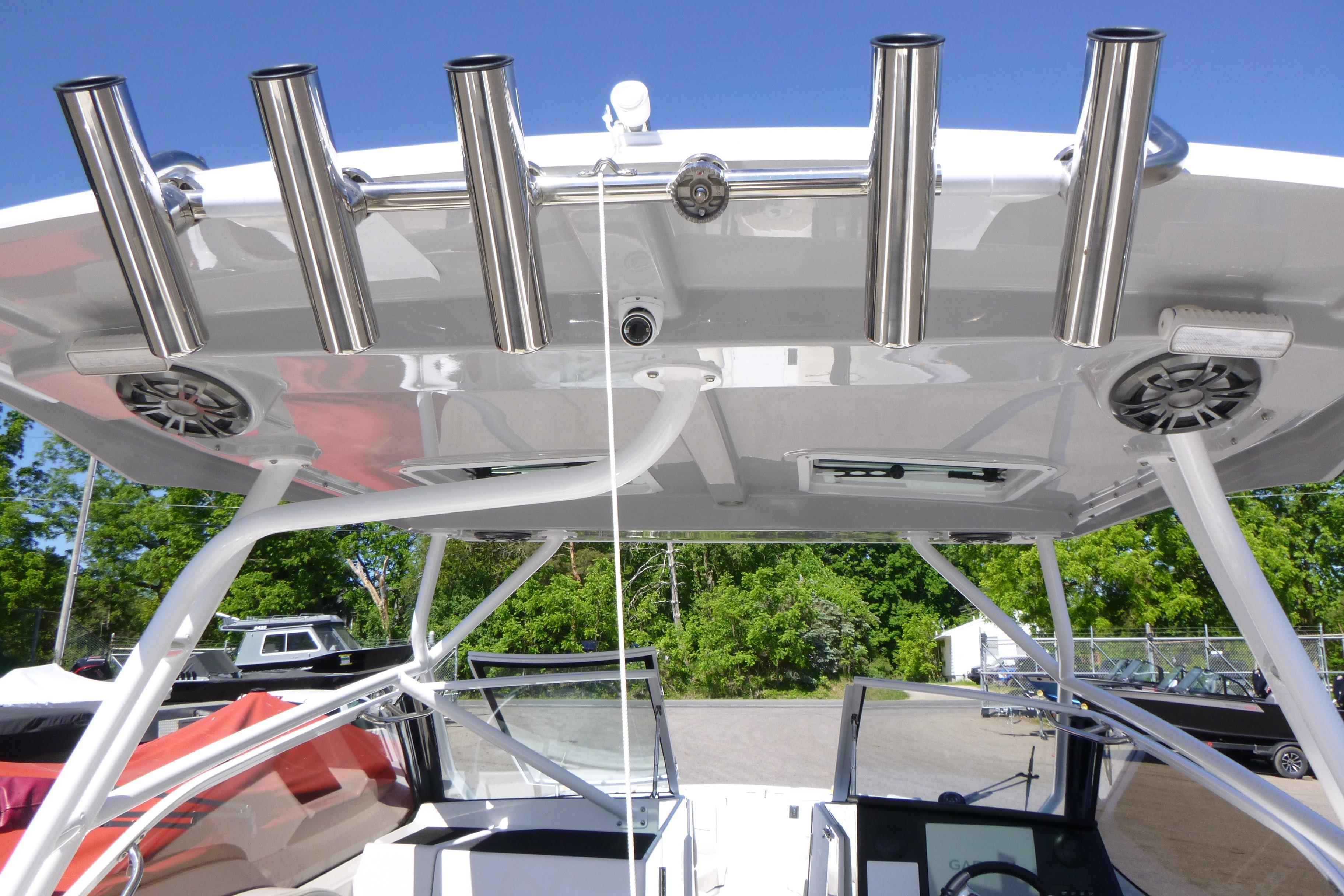 2026 Solara S-250 DC boat with stainless steel rod holders and speakers on the canopy.
