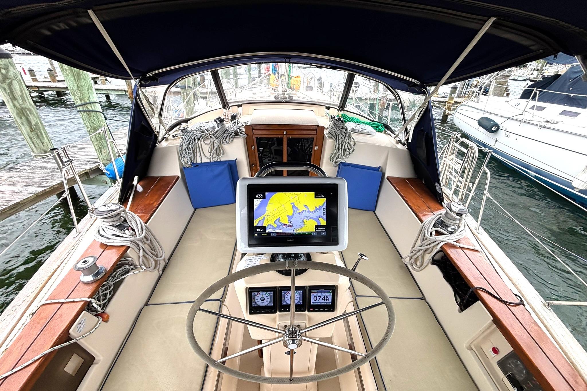 Cockpit of 2001 Island Packet 380 sailboat with navigation equipment and steering wheel.