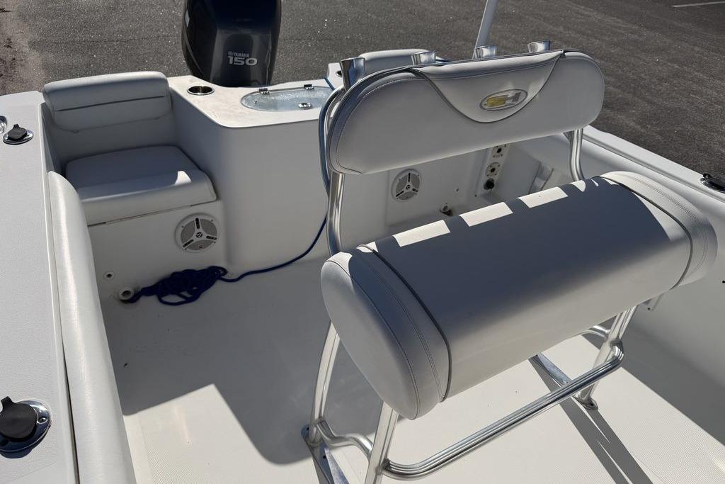 2011 Sea Hunt Triton 225 boat interior with seating and Yamaha 150 engine.