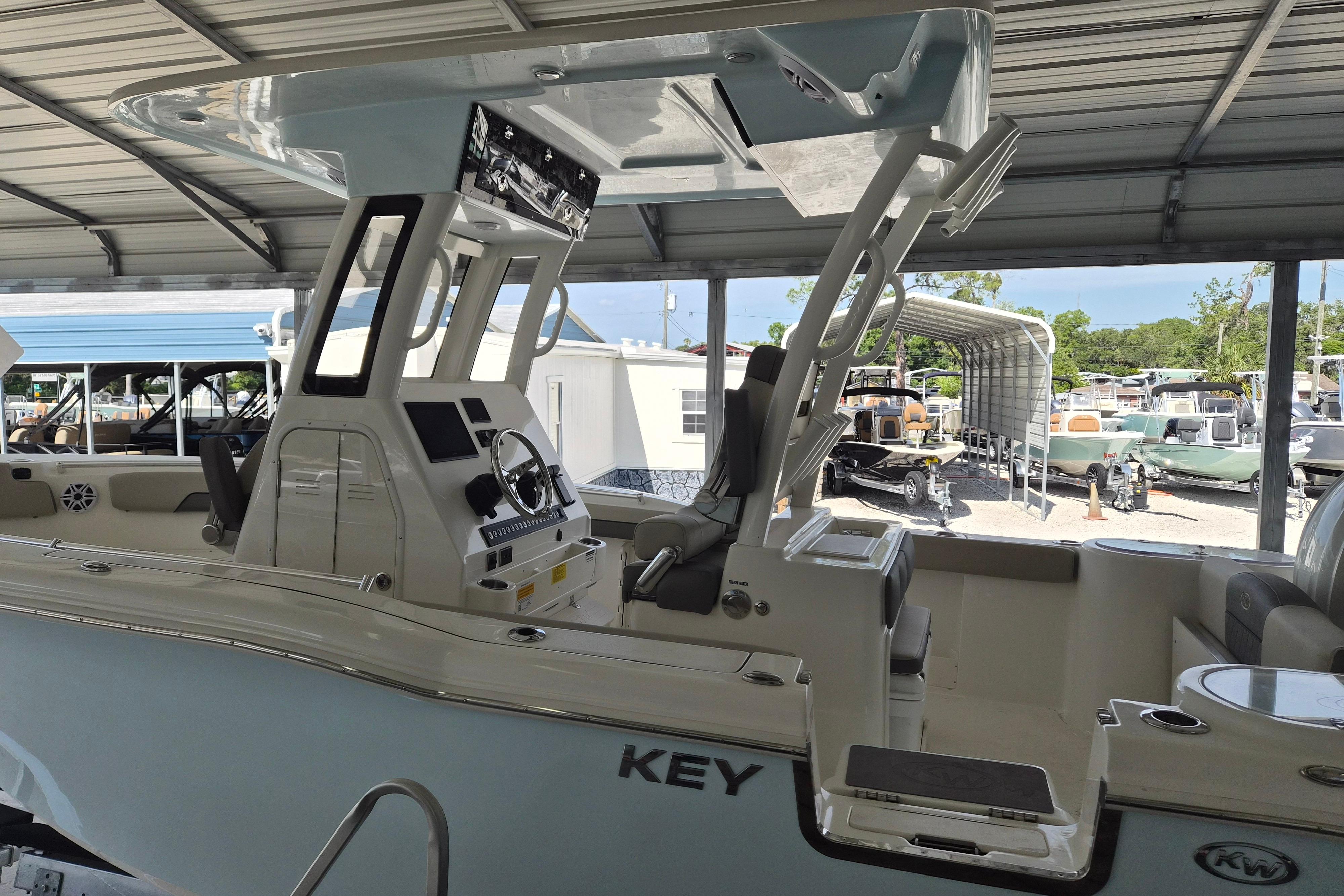 2026 Key West 260 Center Console boat in a covered marina, showcasing helm and seating area.