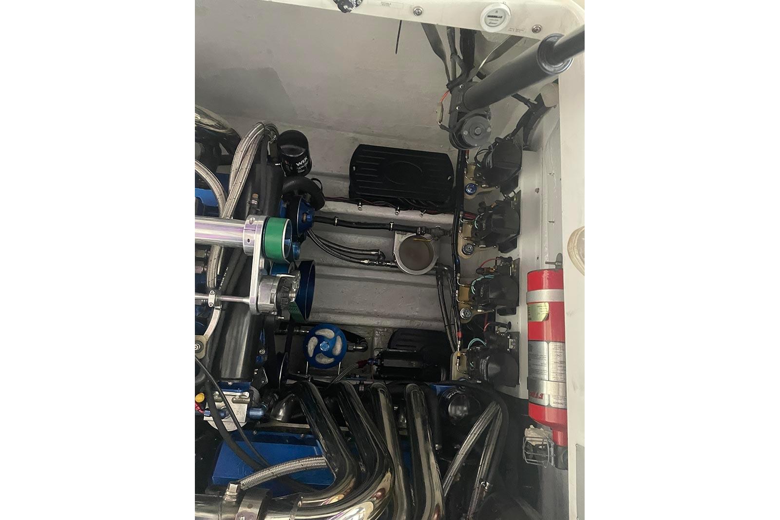 Engine compartment of a 2004 Fountain 38 Lightning boat, showcasing mechanical components and fire extinguisher.