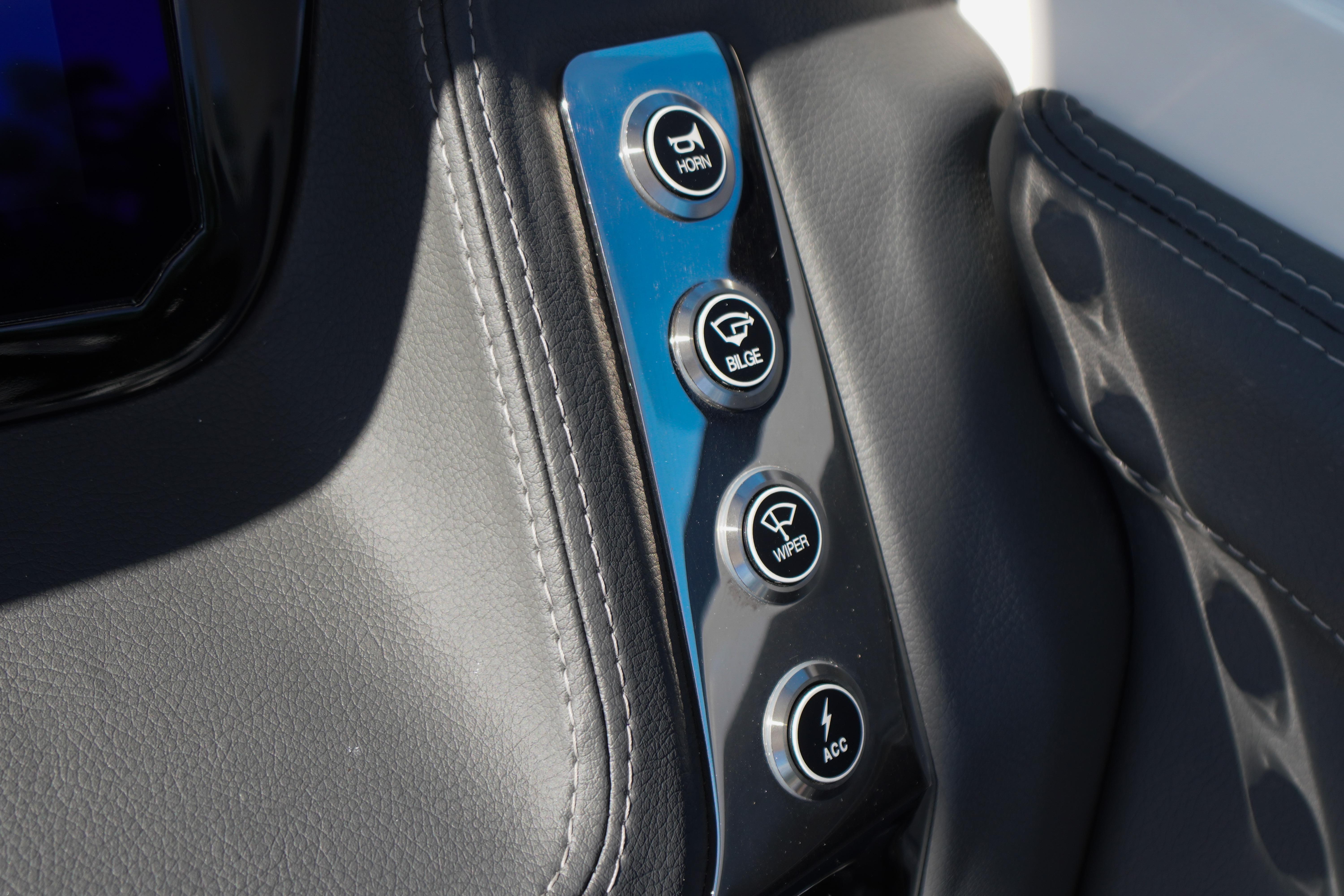 Control panel of 2026 Chaparral 270 OSX boat with horn, bilge, wiper, and accessory buttons.