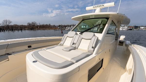 2025 Scout 425 LXF luxury boat with Garmin equipment, docked on a sunny day.