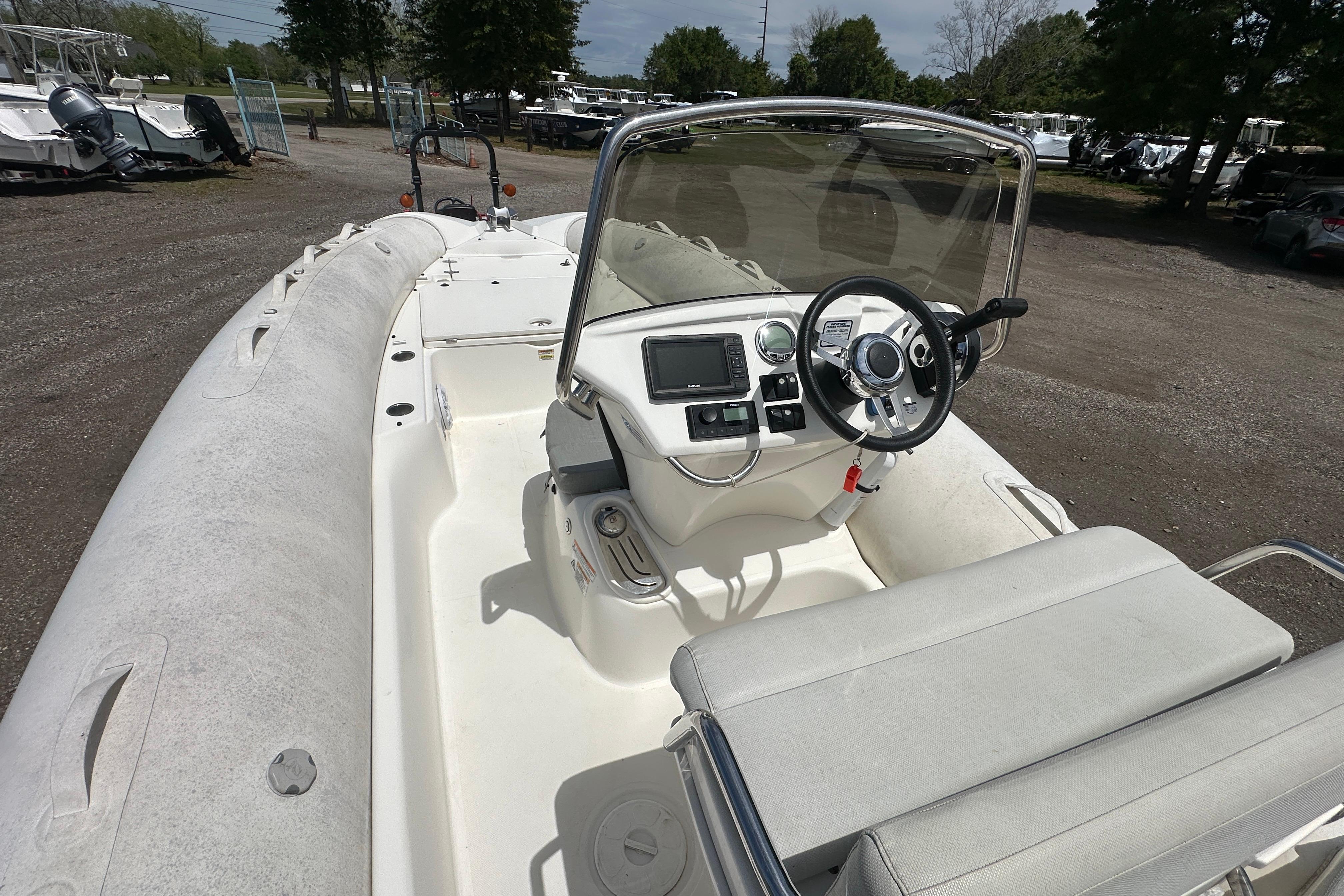 2023 Zodiac N-ZO 680 boat interior with steering console and seating, parked outdoors.