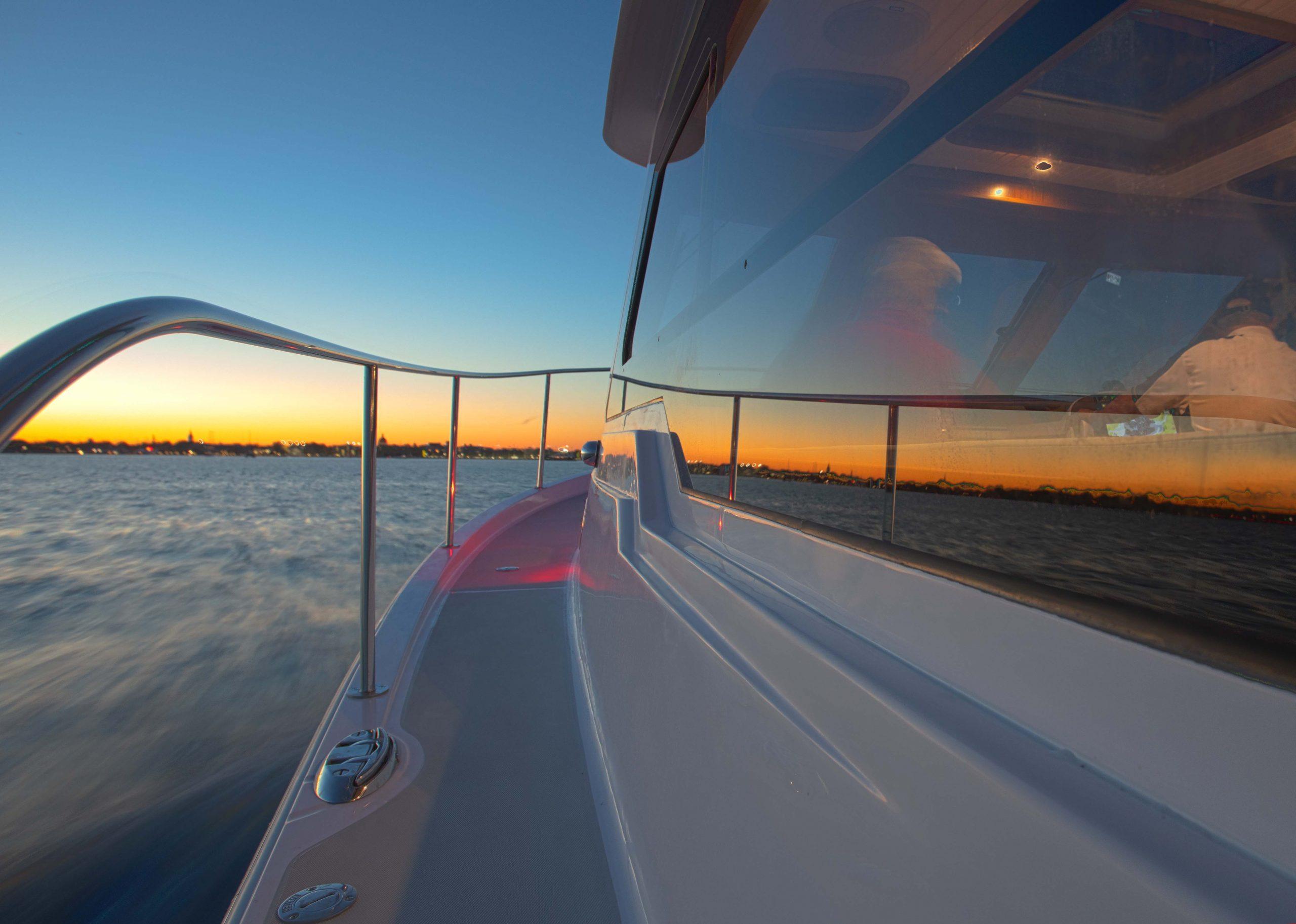 2024 True North 34 boat cruising at sunset on calm waters.