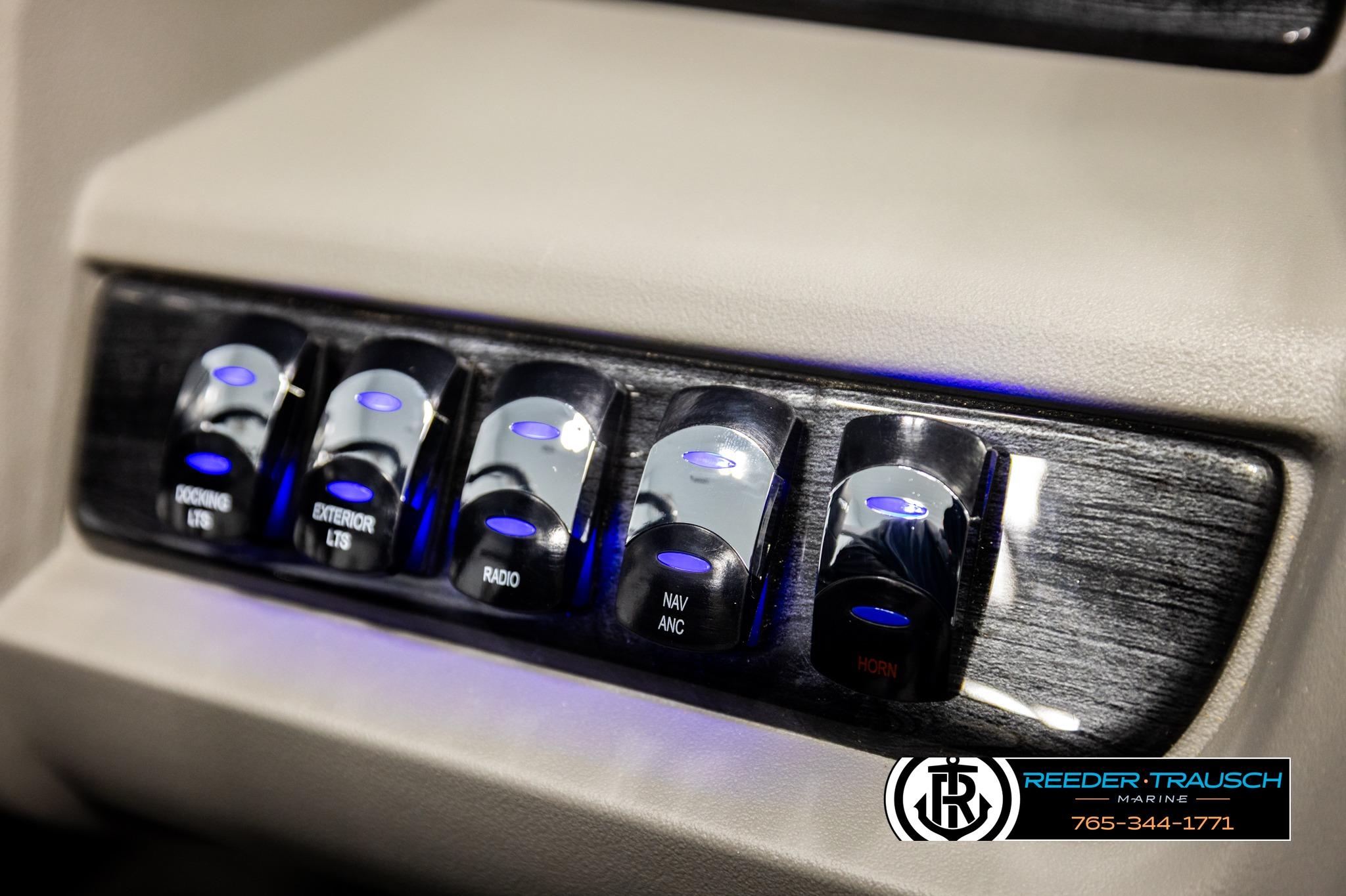 Control panel of 2026 Avalon LSZ Vrl with illuminated switches for docking, lights, radio, and horn.