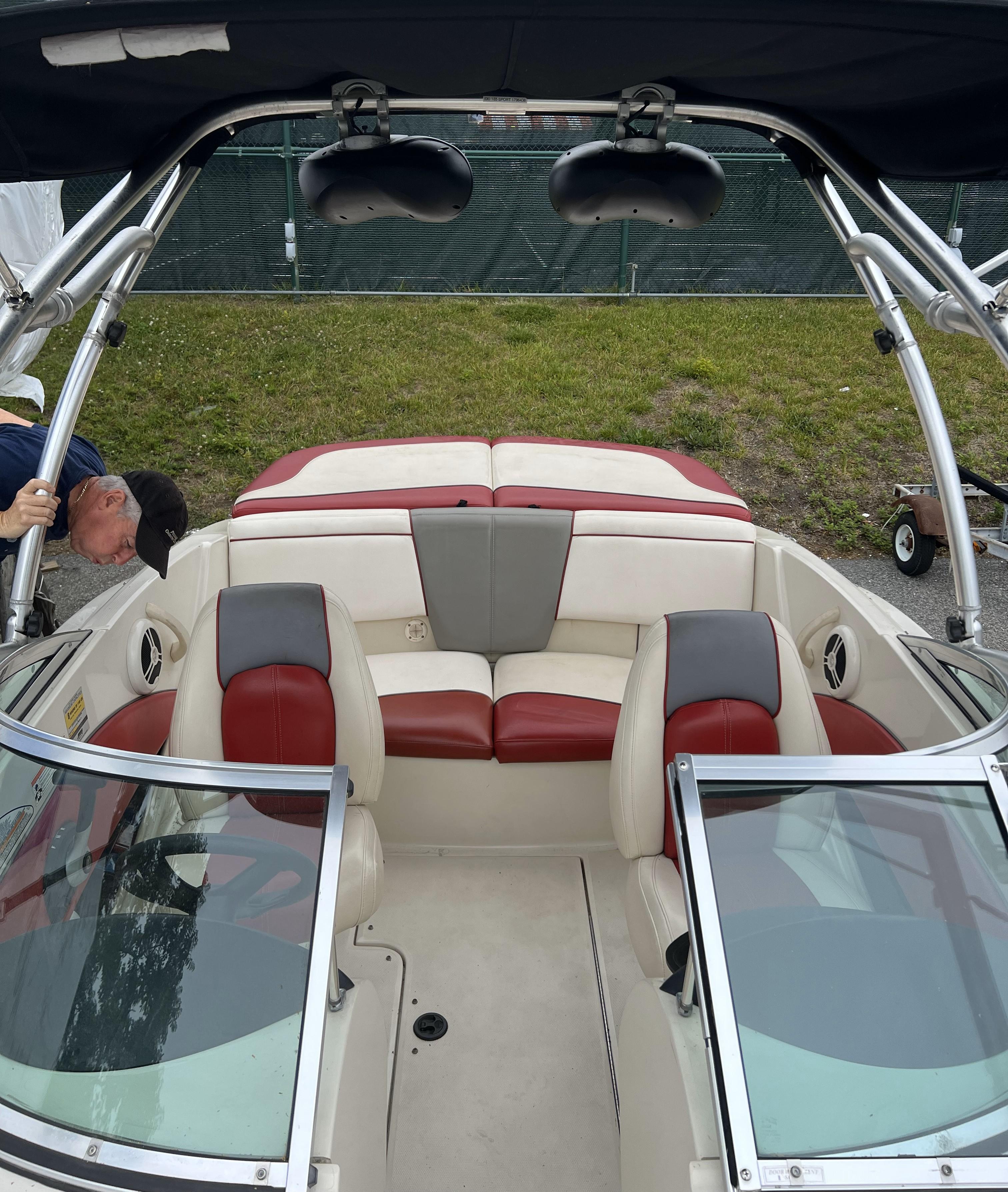 2007 Sea Ray 185 Sport boat interior with red and gray seating, open windshield, and wakeboard tower.