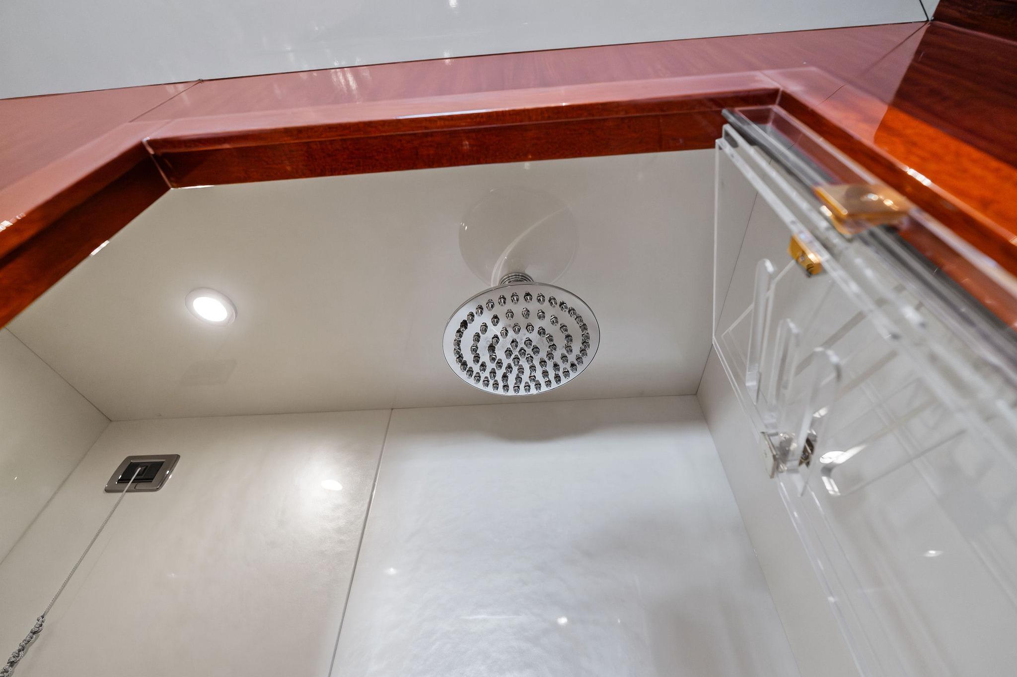 Luxurious shower area in 2005 Mangusta 130 yacht with modern fixtures and elegant design.