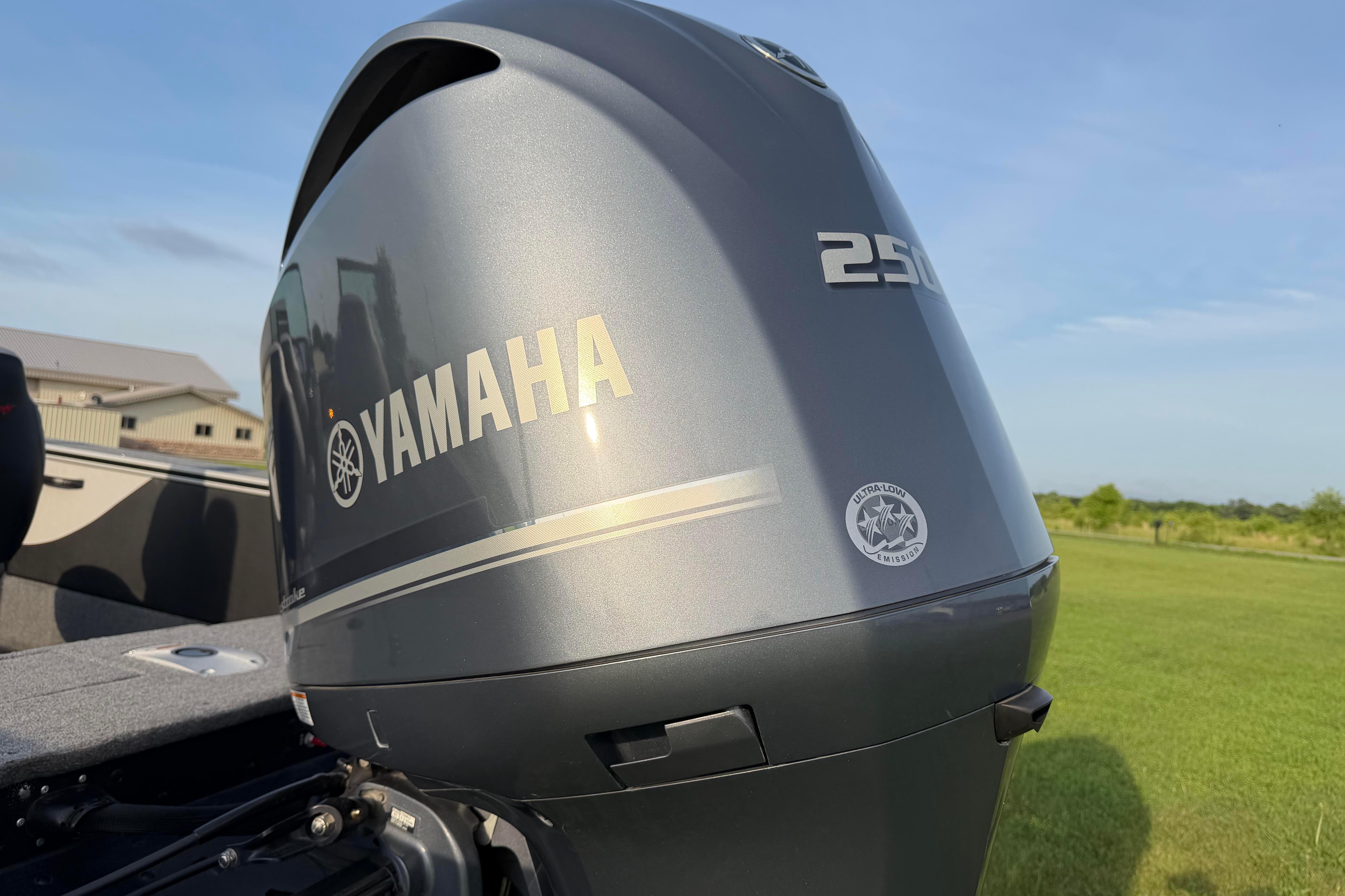 Yamaha 250 outboard motor on 2019 Alumacraft Trophy 205 boat, outdoors.