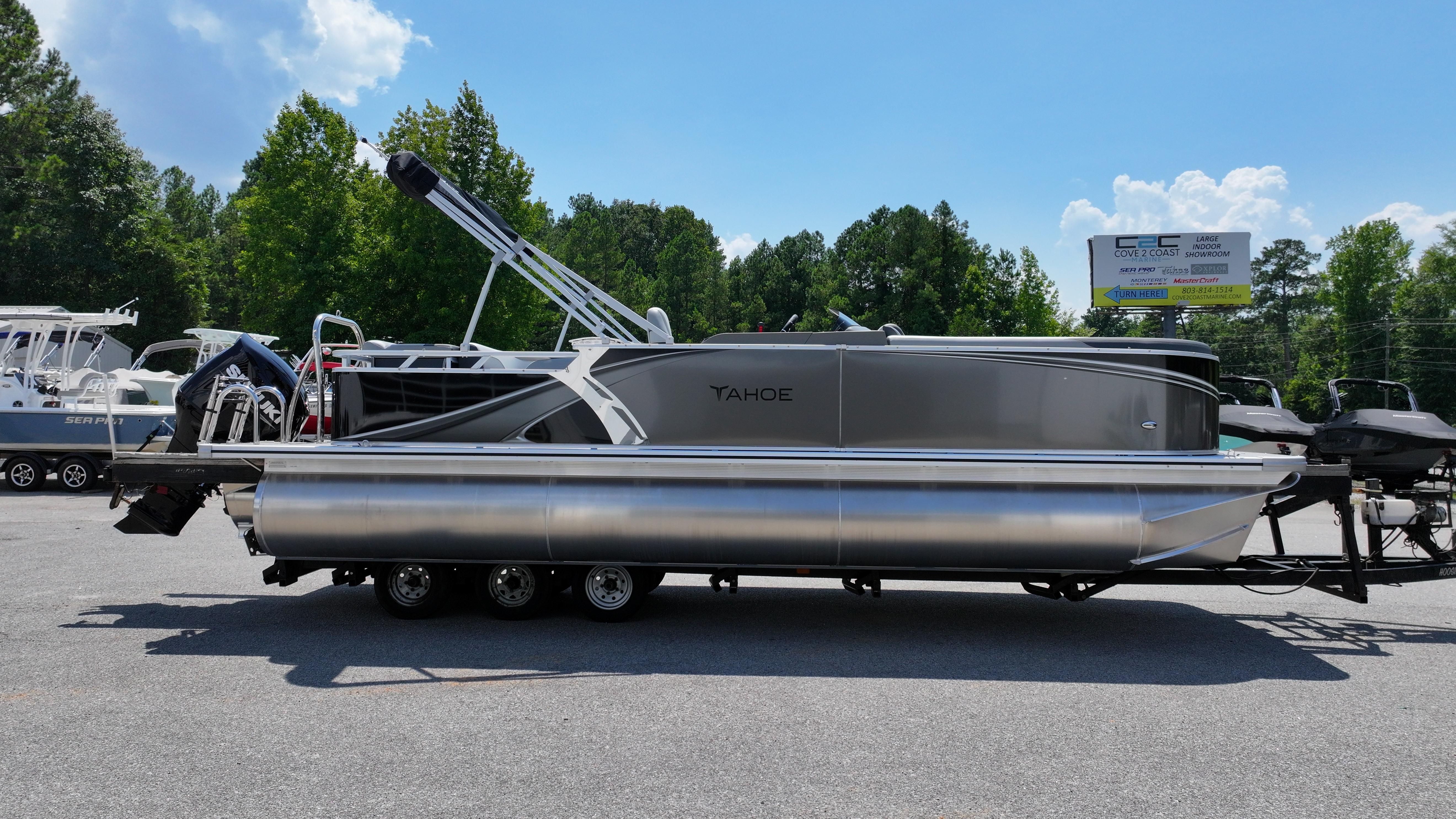 2025 Tahoe Pontoon LTZ Cruise boat on trailer, parked outdoors under clear sky.