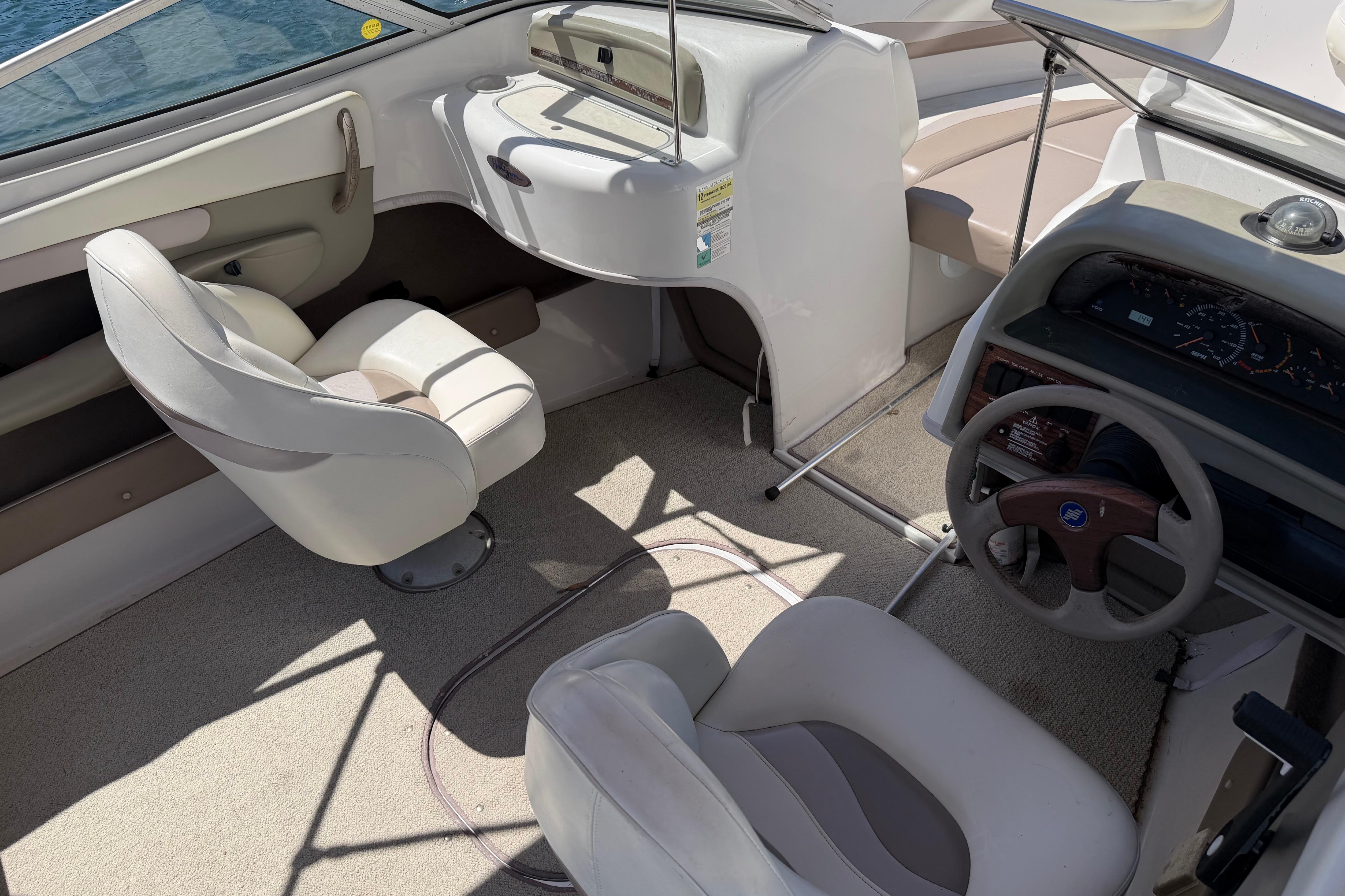 1998 Four Winns 220 Horizon boat interior with steering wheel and seating.