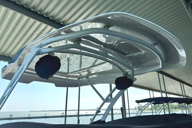 2021 Yamaha Boats 275SD with sleek canopy design docked under shelter.