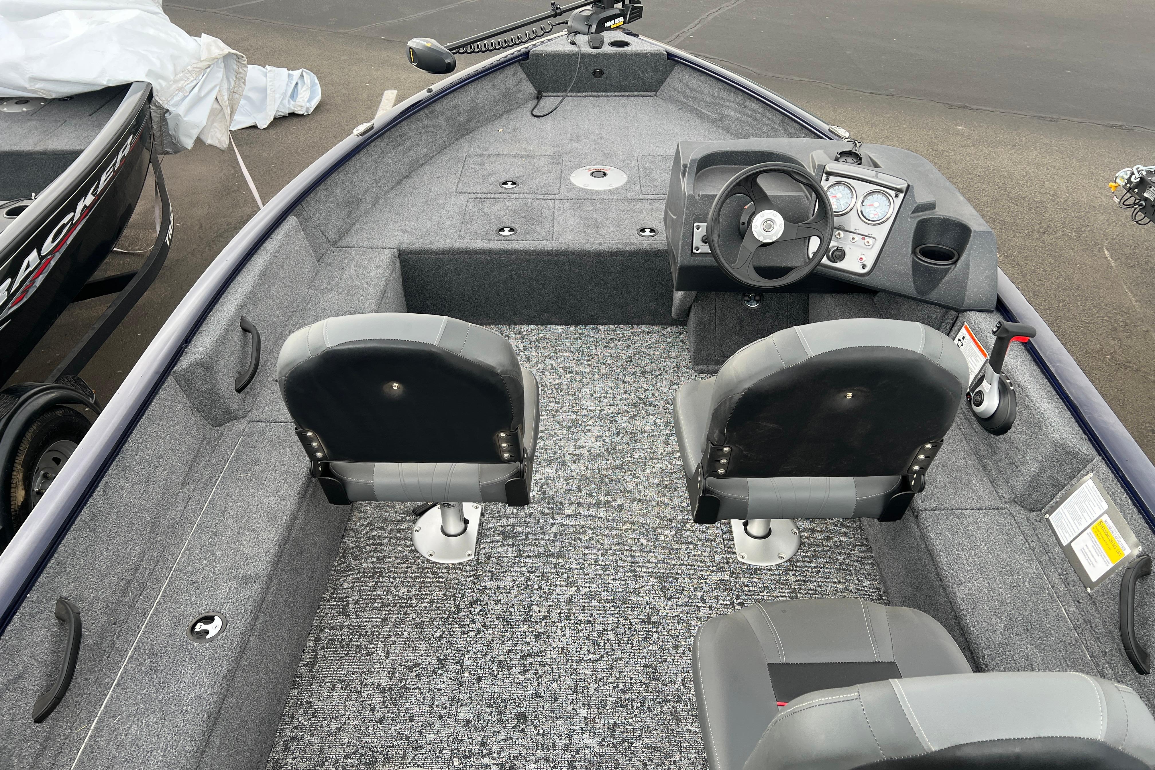2026 Tracker Pro Guide V-16 SC boat interior with steering console and seating.