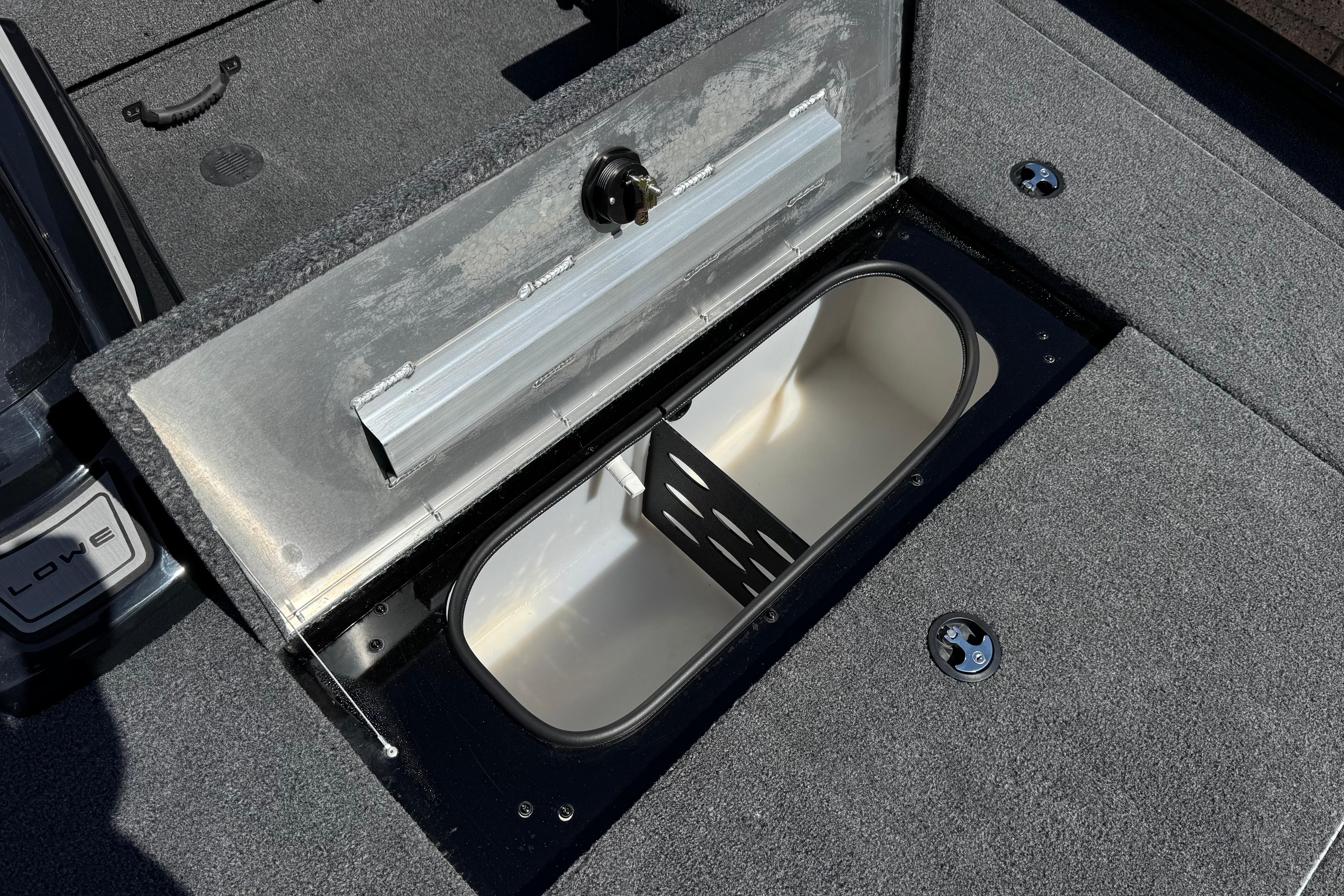 2024 Lowe Stinger 175 boat storage compartment with open lid, showcasing interior space.