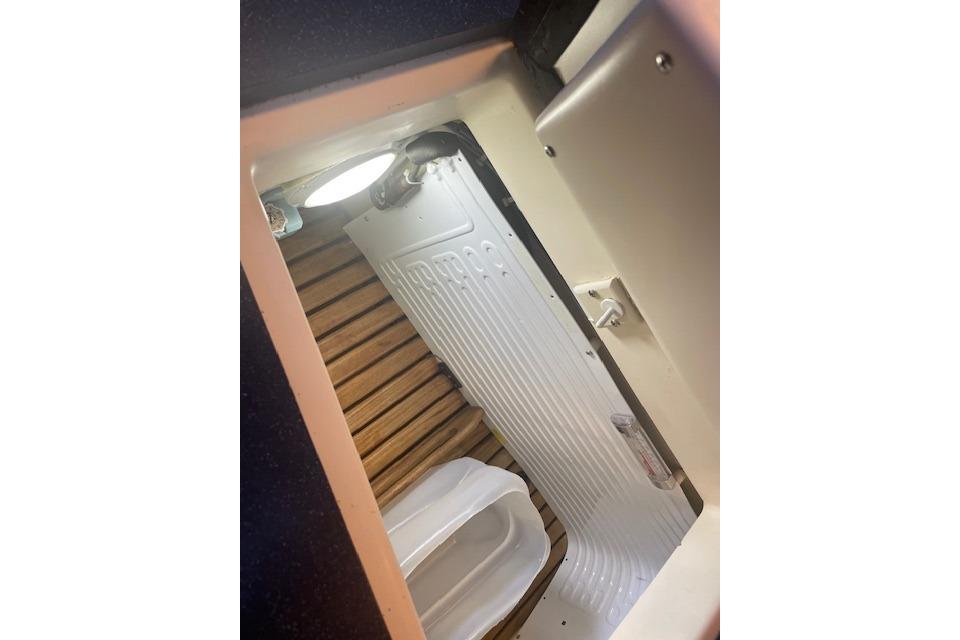 Interior view of a 2001 Tartan 3700 sailboat, featuring a compact storage area.