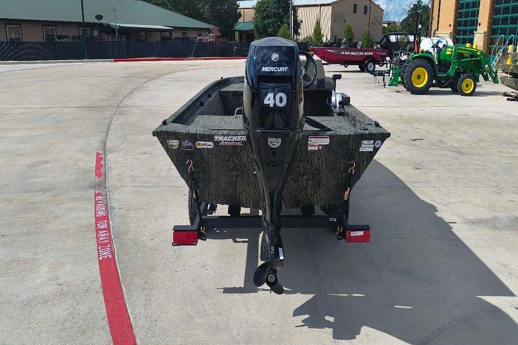 2026 Tracker Grizzly 1648 SC boat with Mercury 40 engine, parked outdoors.