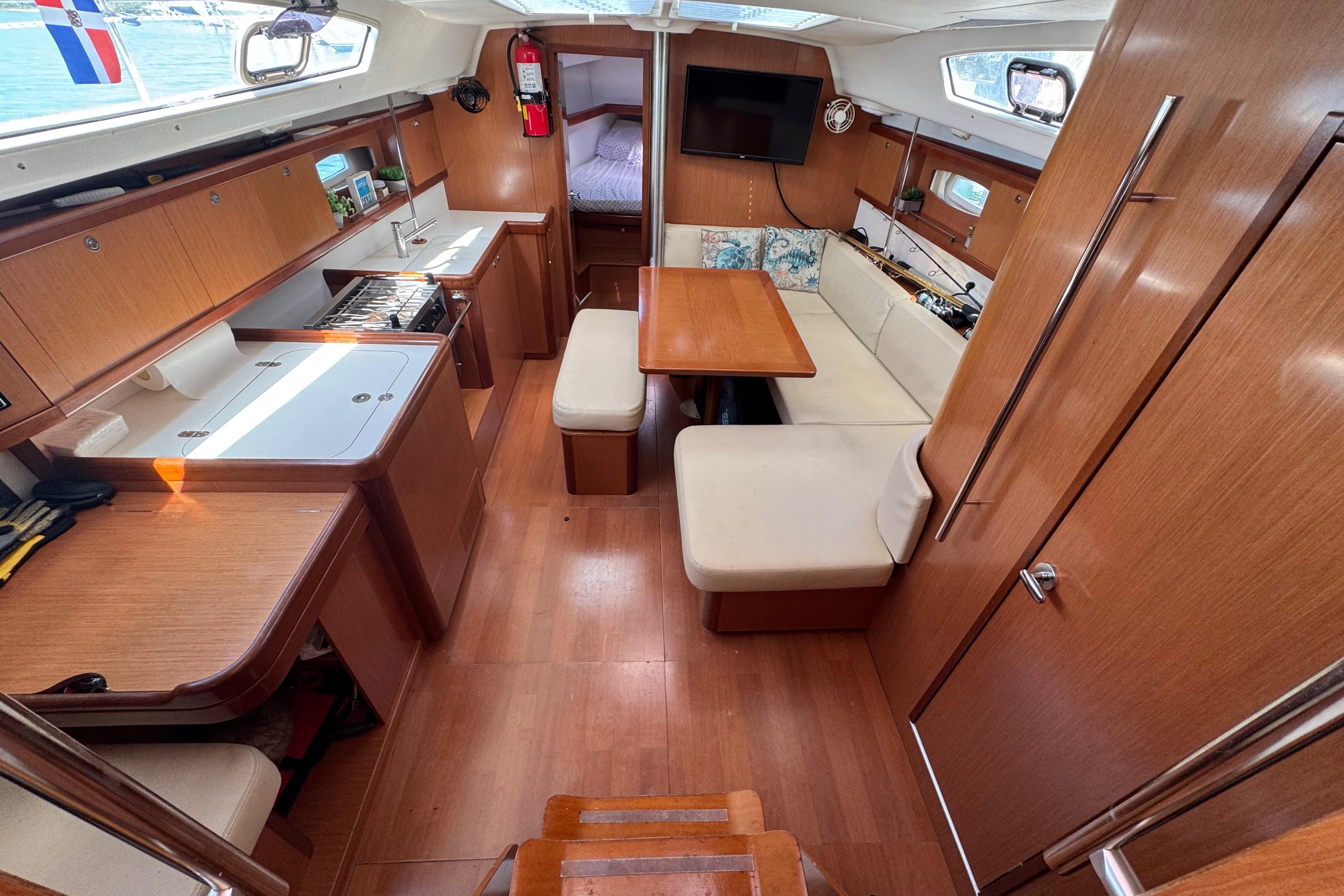 Interior of 2008 Beneteau Oceanis 40 sailboat with wood finish and cozy seating area.