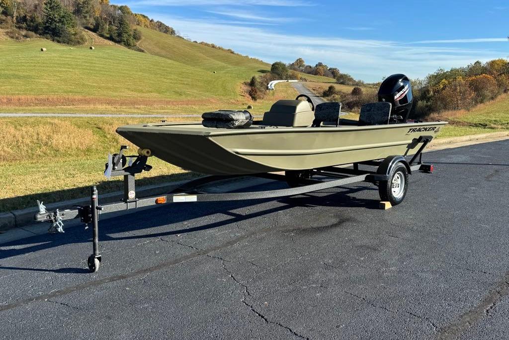 2026 Tracker Grizzly 1754 SC boat on trailer, parked on a scenic road.