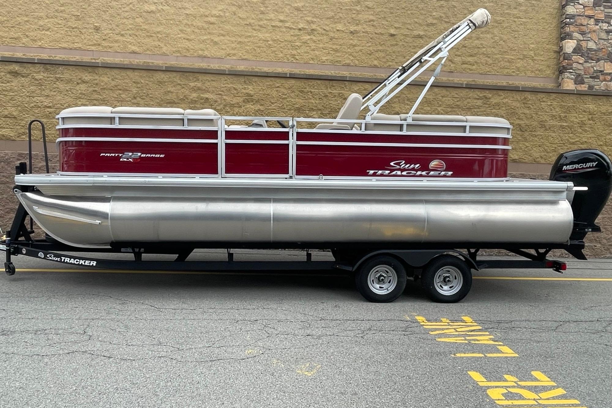2025 Sun Tracker Party Barge 22 XP3 pontoon boat on trailer, side view.
