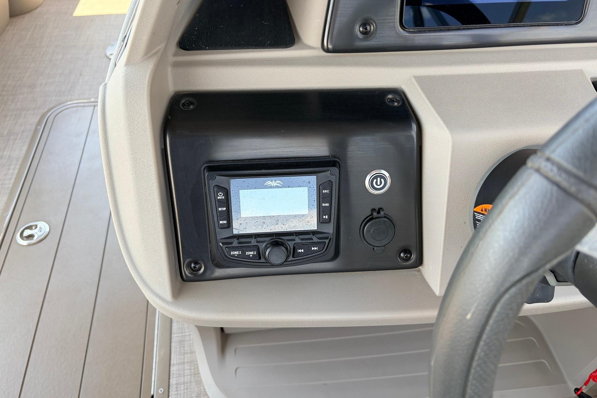 Dashboard of 2024 Sun Tracker SportFish 22 XP3 with control panel and steering wheel.