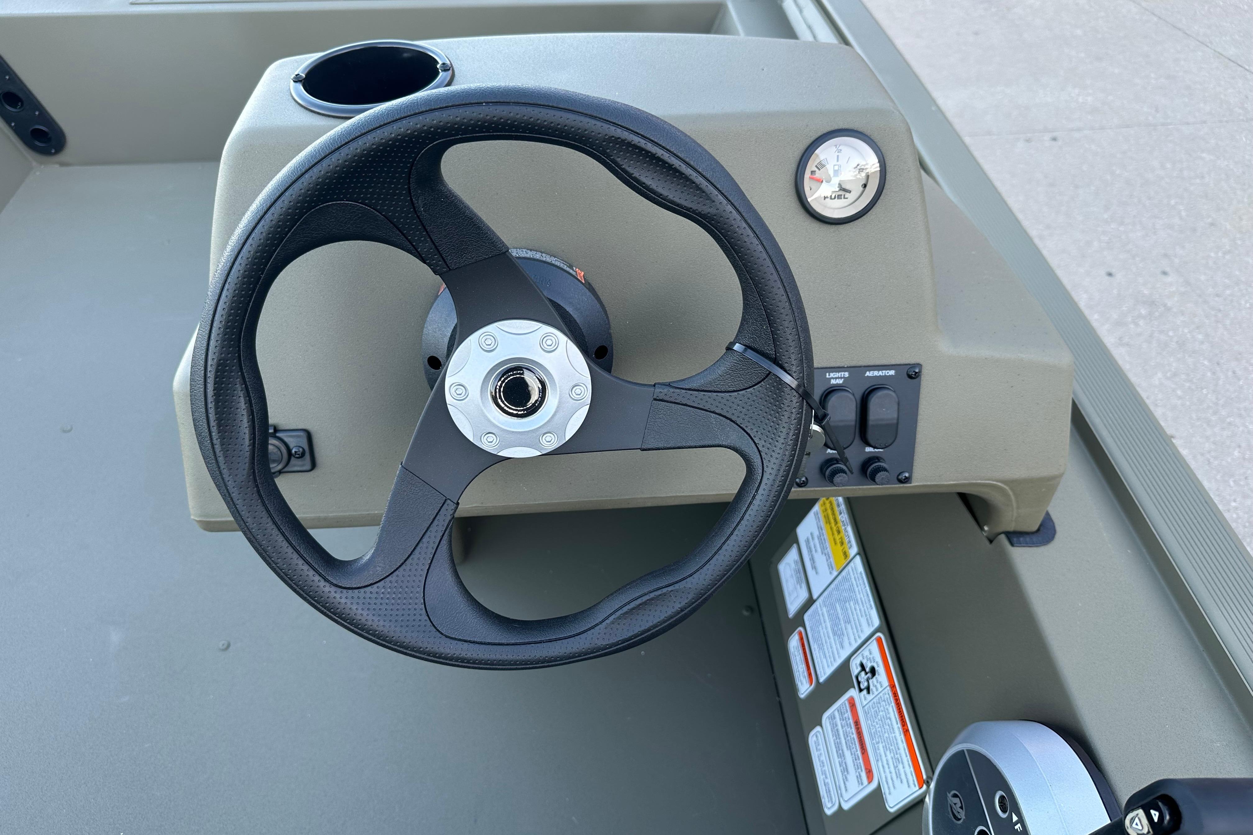 Steering console of 2026 Tracker Grizzly 1754 SC boat with fuel gauge and controls.