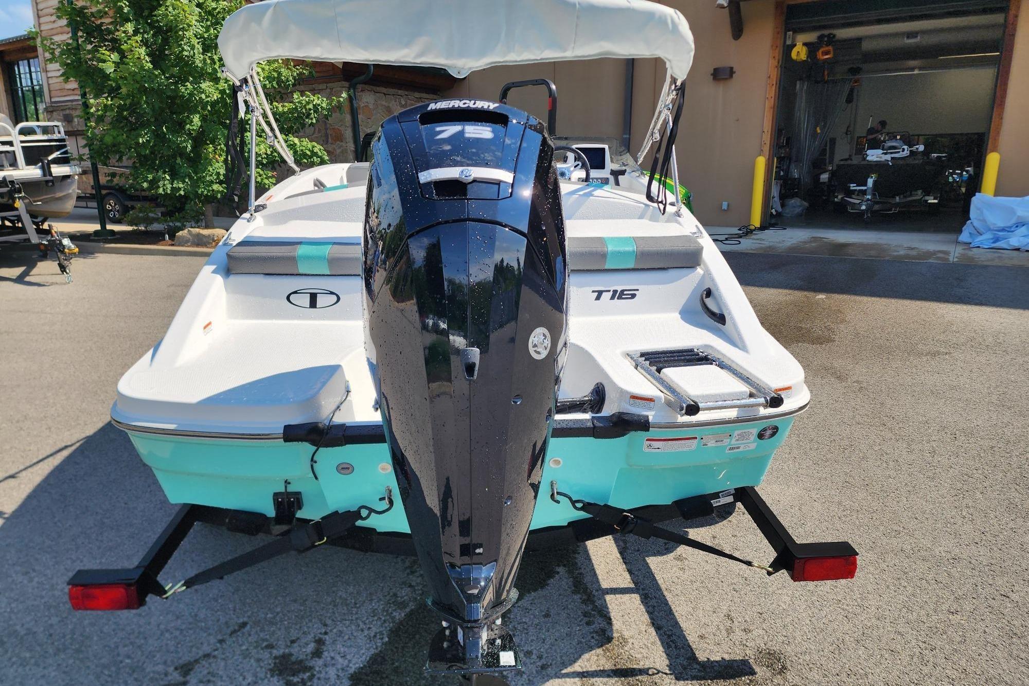 2026 Tahoe T16 boat with Mercury 75 engine, parked outdoors.
