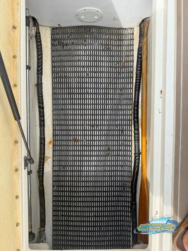 2008 Sea Ray 270 SLX boat compartment with black mat and visible wiring.