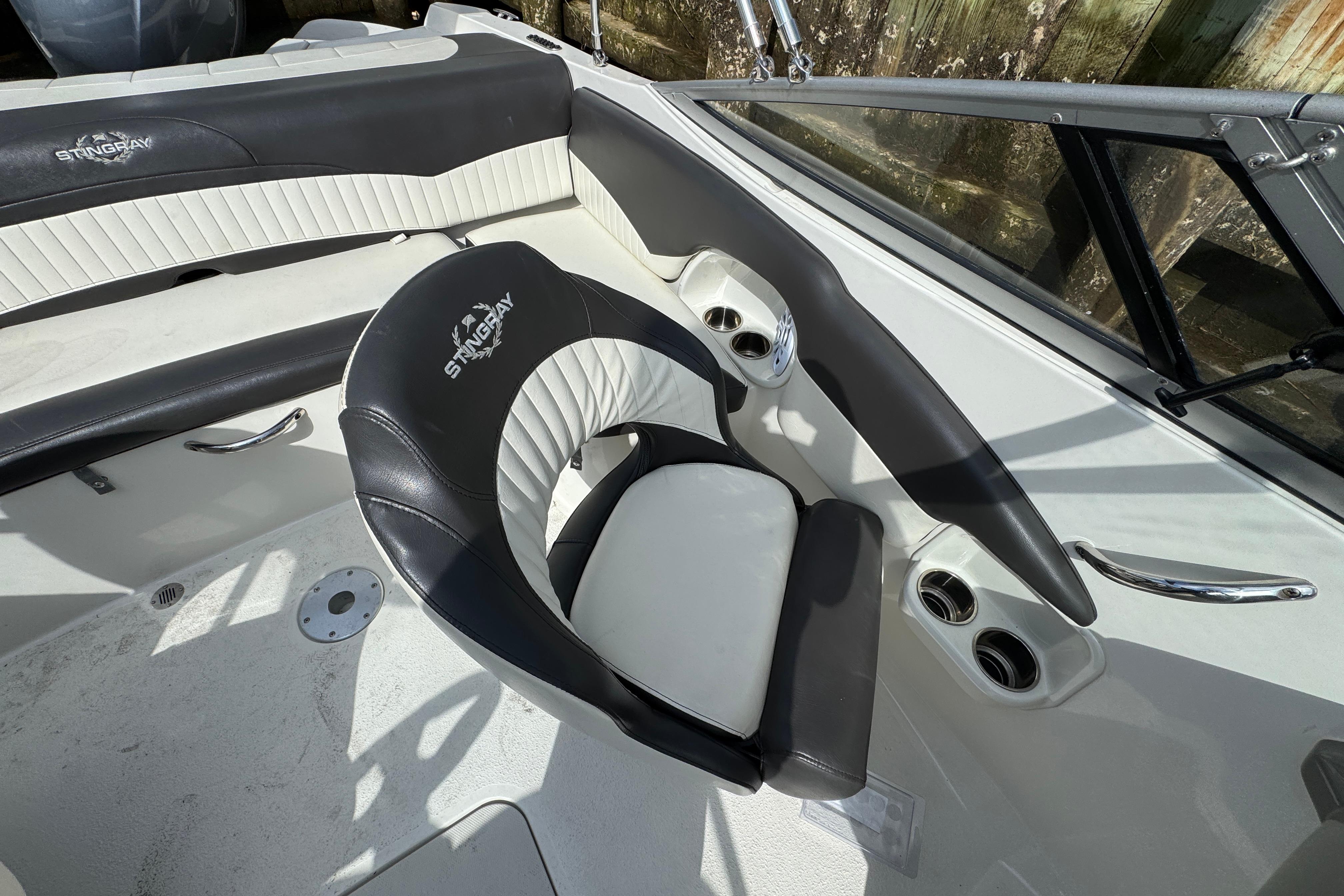 2019 Stingray 204 LR boat interior with black and white seating and cup holders.