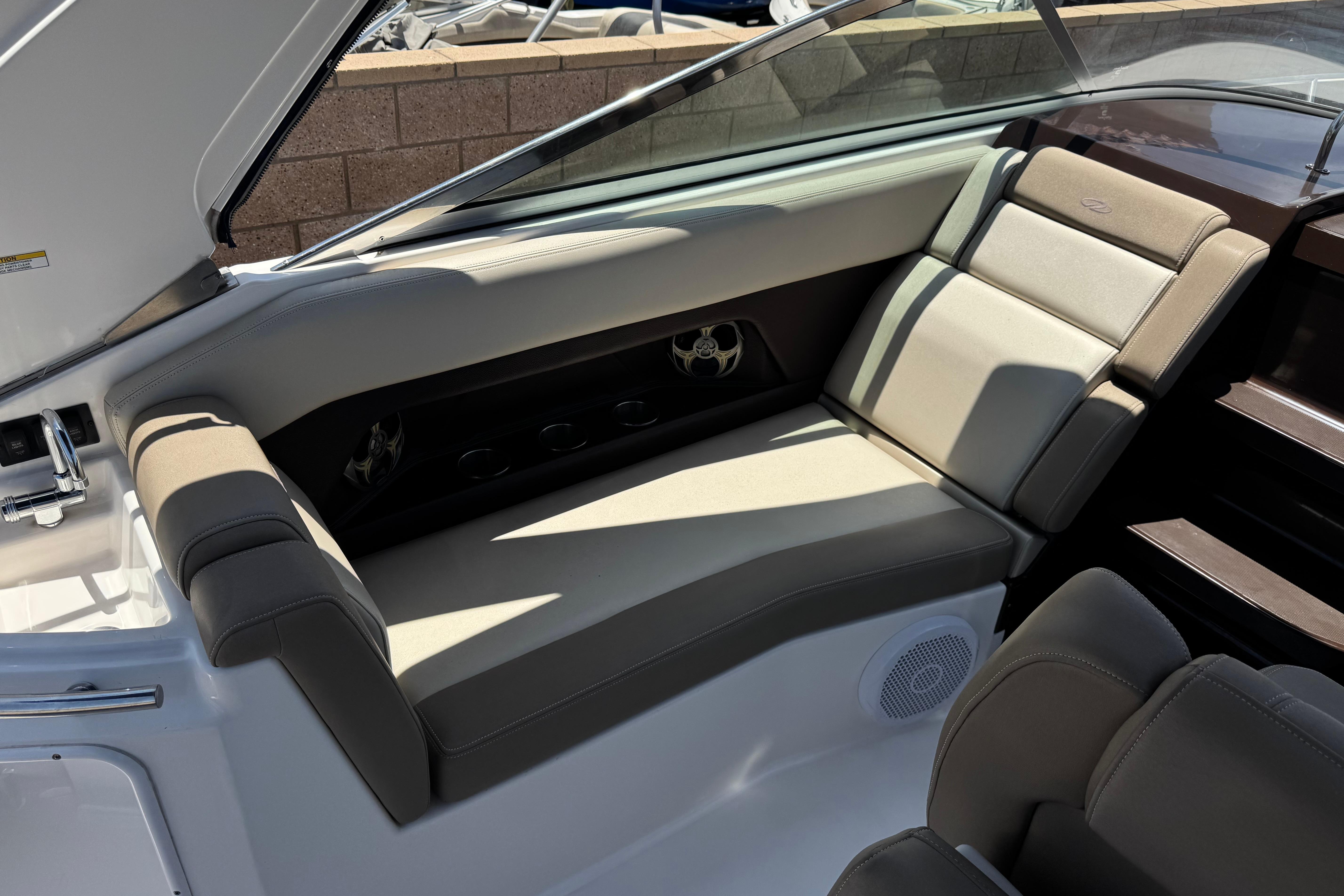 Interior seating of a 2013 Regal 28 Express boat, featuring beige upholstery.