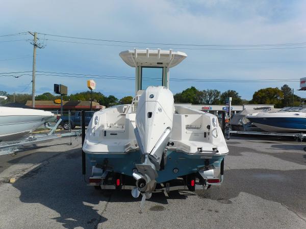 2025 Sailfish 232 CC boat, rear view, parked in a marina lot.