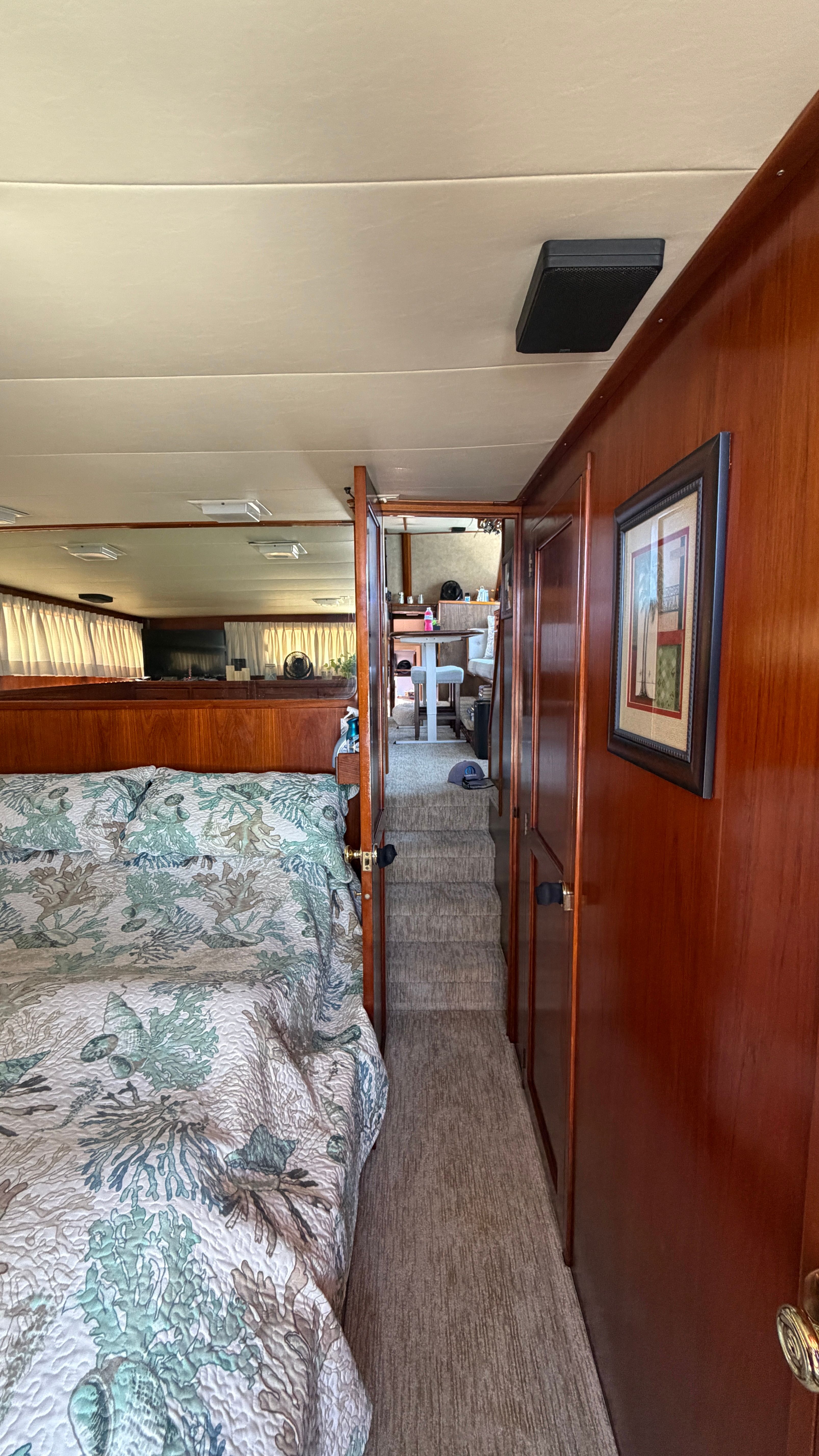Interior of a 1966 Drake Yachtfisher with wood paneling and bed.
