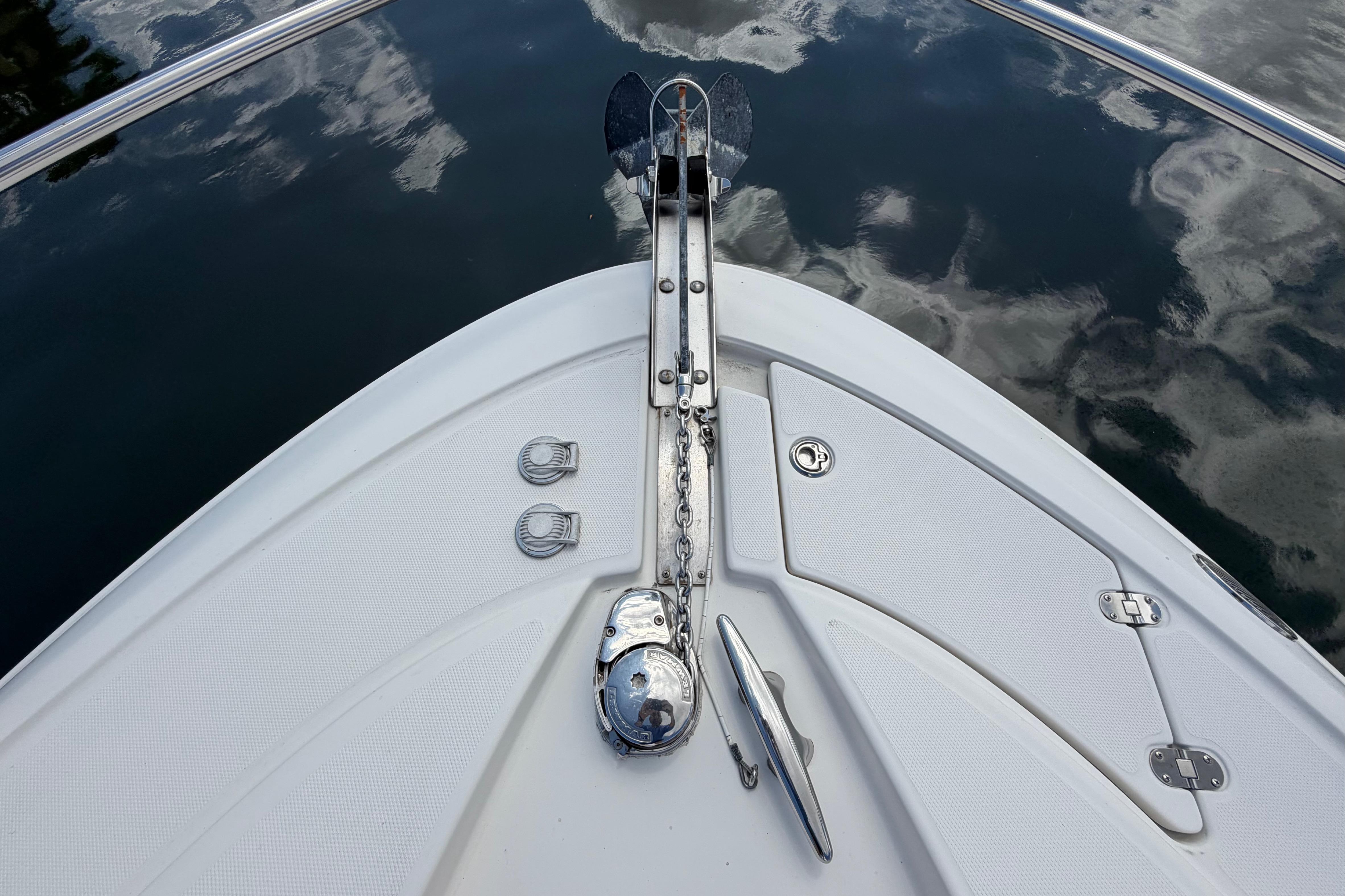 Bow of 2007 Monterey 350 Sport Yacht with anchor and calm water reflection.