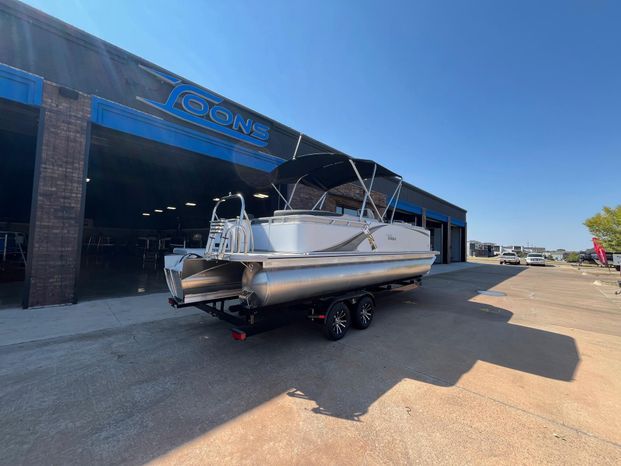 2025 Tahoe LTZ QL pontoon boat outside warehouse.