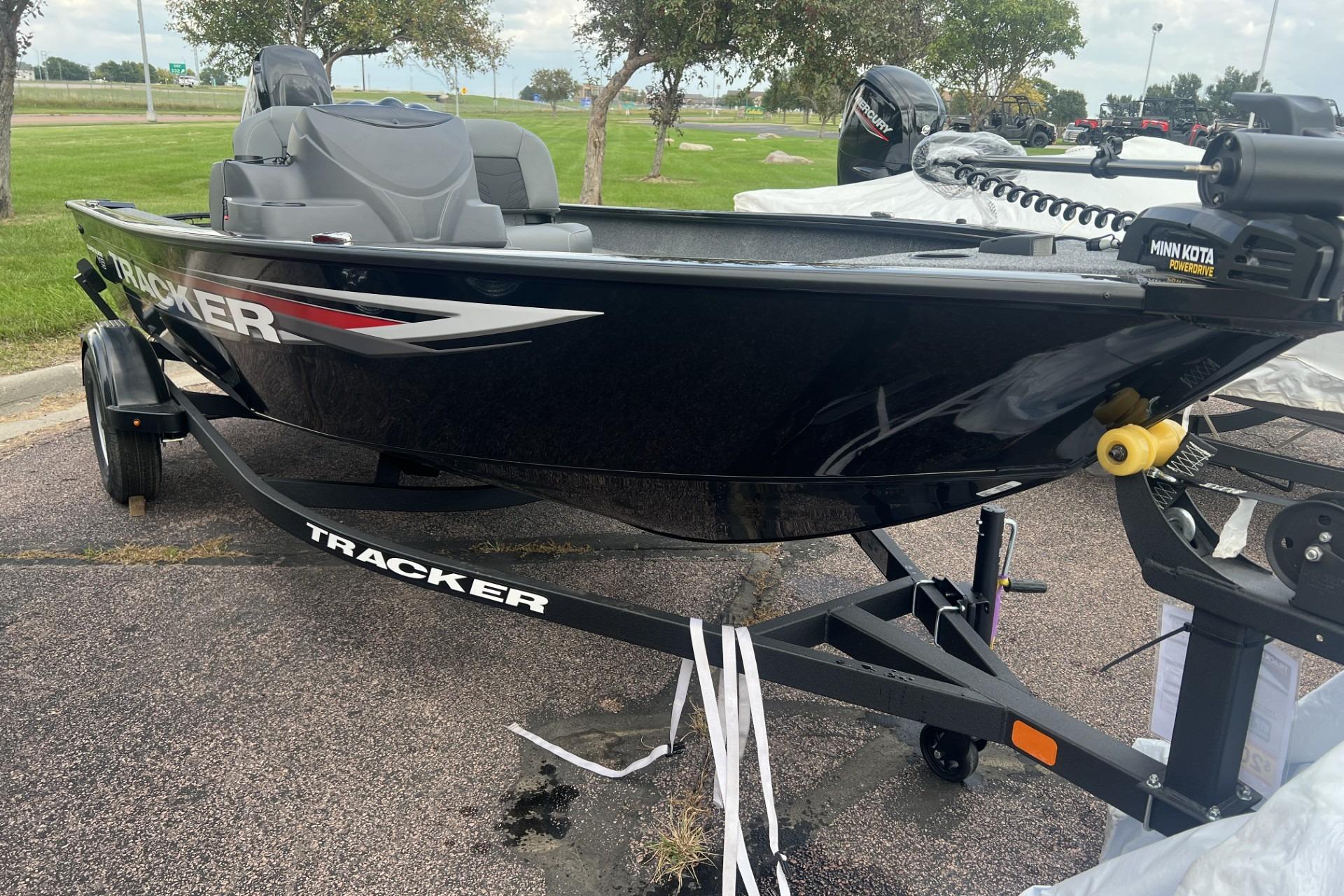 2026 Tracker Super Guide V-16 SC boat on trailer, parked outdoors.