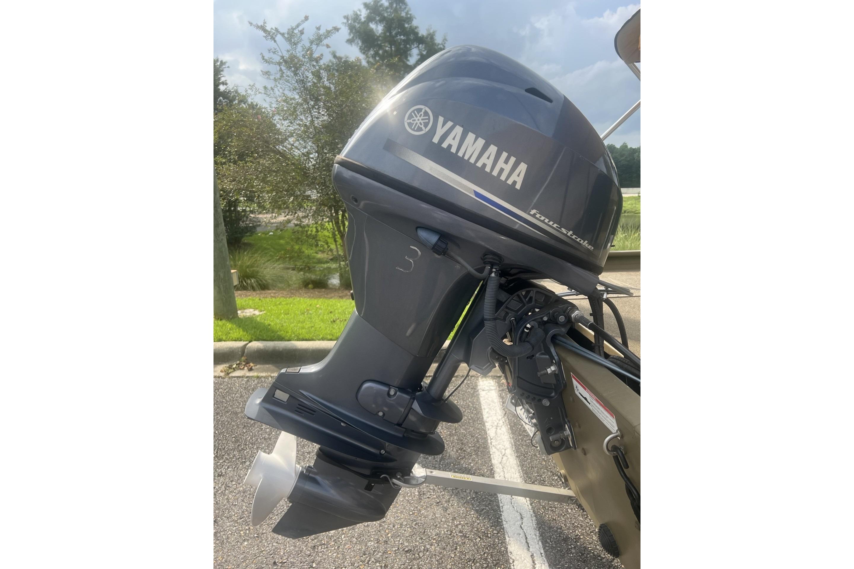 2016 G3 1756 SC boat with Yamaha four-stroke outboard motor in parking lot.