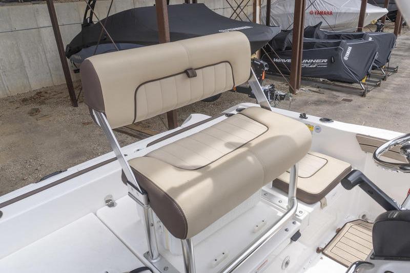 2023 Yamaha Boats 195 FSH Sport interior seating, featuring beige and brown cushioned seats.