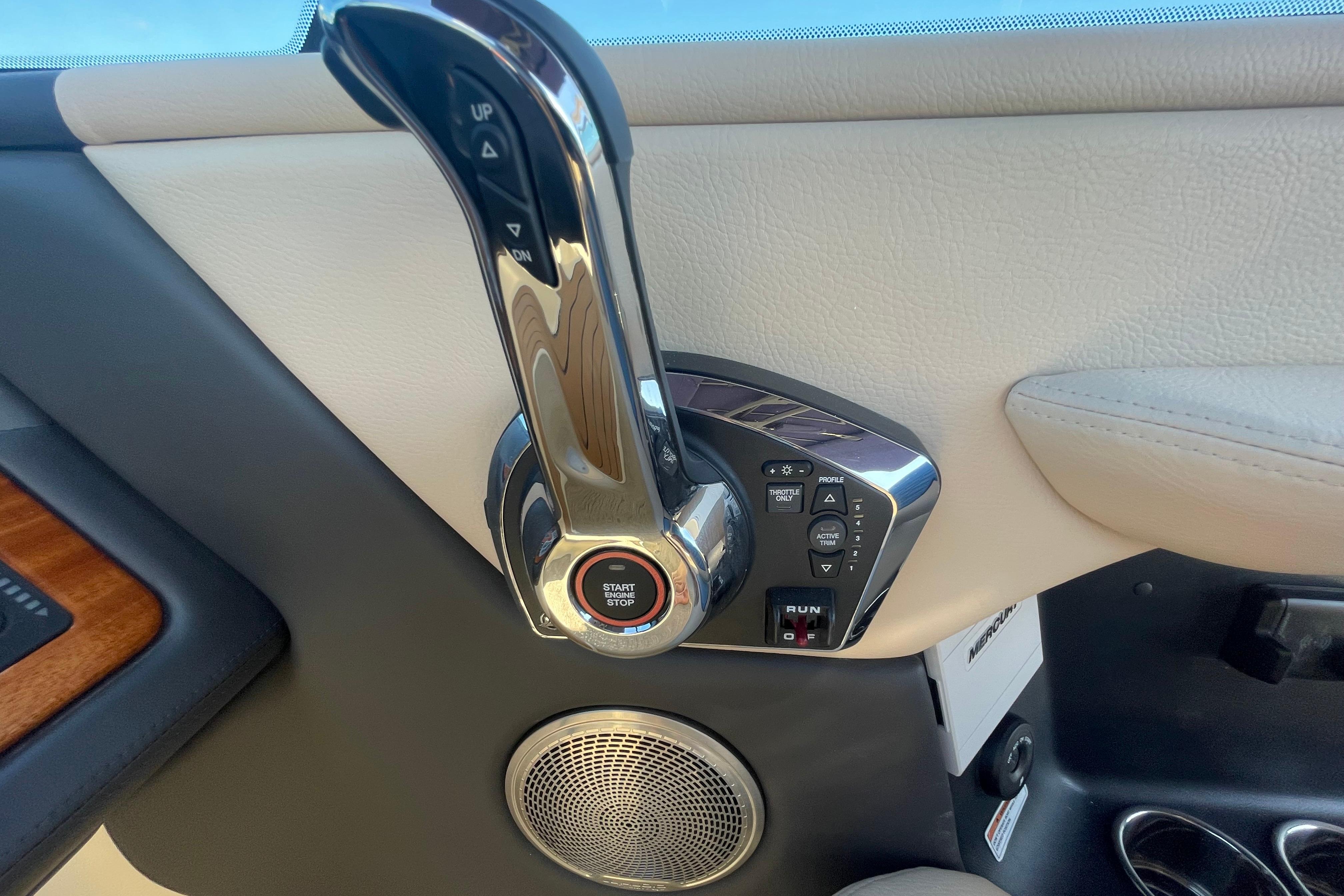2026 Chris-Craft Sportster 28 throttle control with start/stop button and speaker detail.