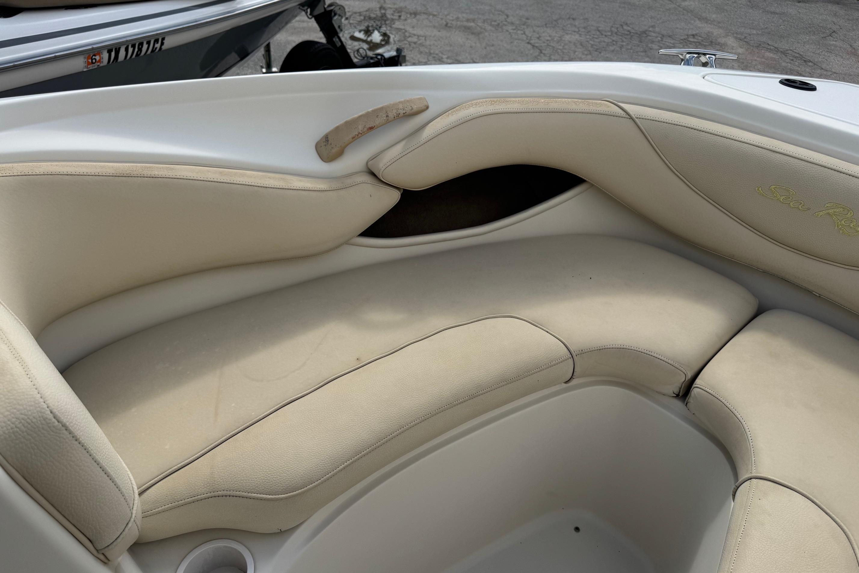 Interior seating of a 2001 Sea Ray 210 Bow Rider boat, featuring beige upholstery.