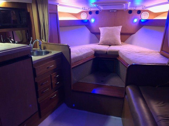 Interior of a 2005 Luhrs 32 Open with cozy sleeping area and kitchenette.