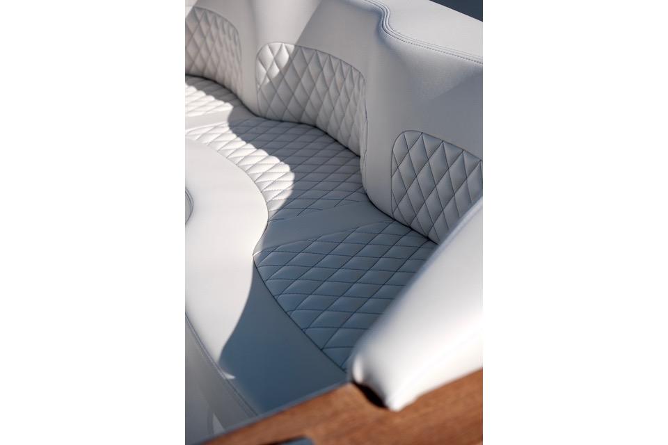 Luxurious white quilted seating in 2018 Carbon Craft CC130 boat interior.