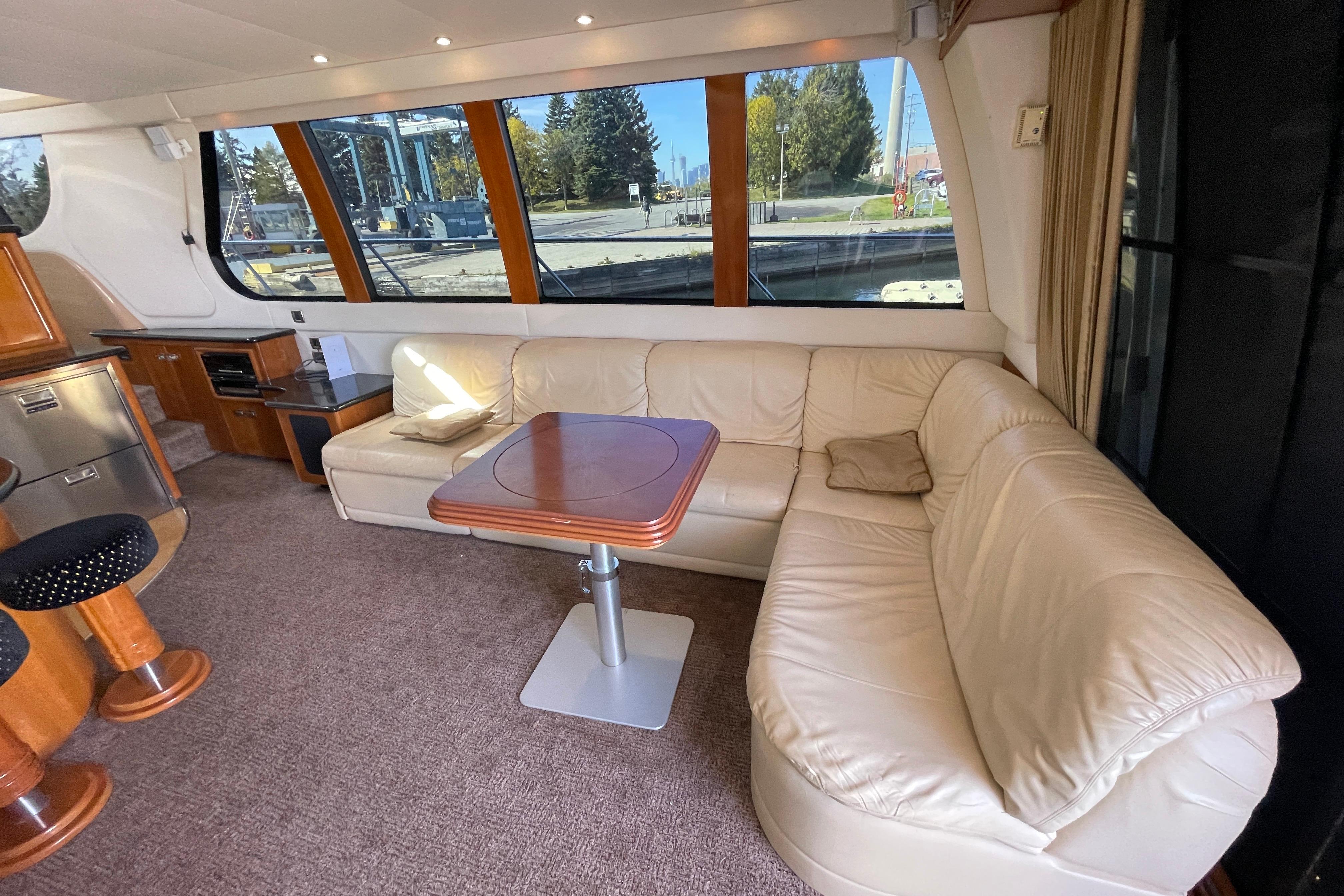 Luxurious interior of 2002 Carver 570 Voyager Pilothouse with leather seating and wooden accents.