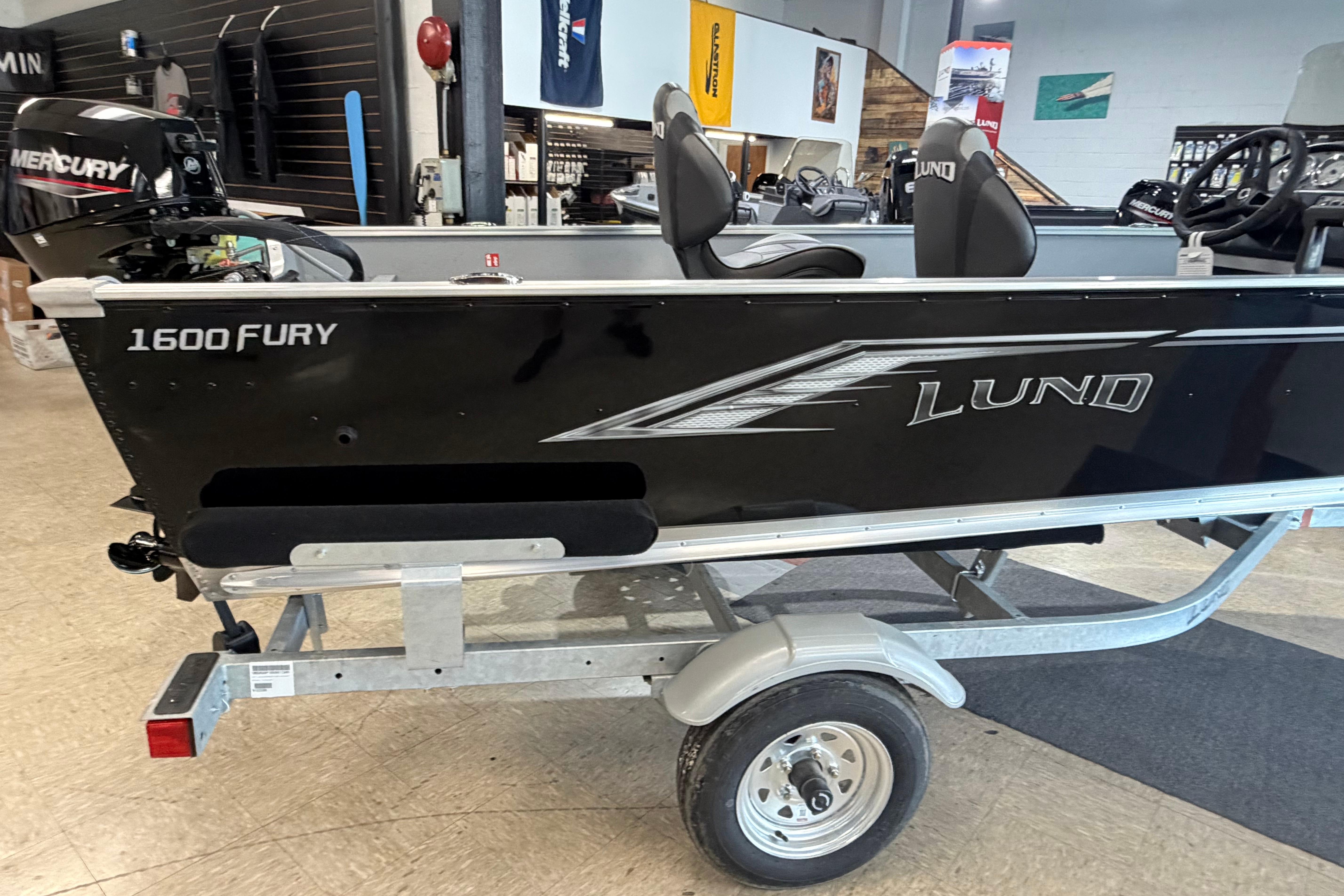 2027 Lund 1600 Fury SS boat on trailer in showroom.