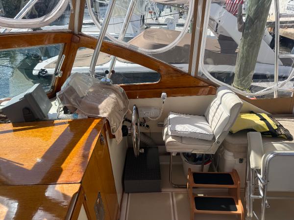1978 Dyer 29 Trunk Cabin boat interior with steering wheel and seating.