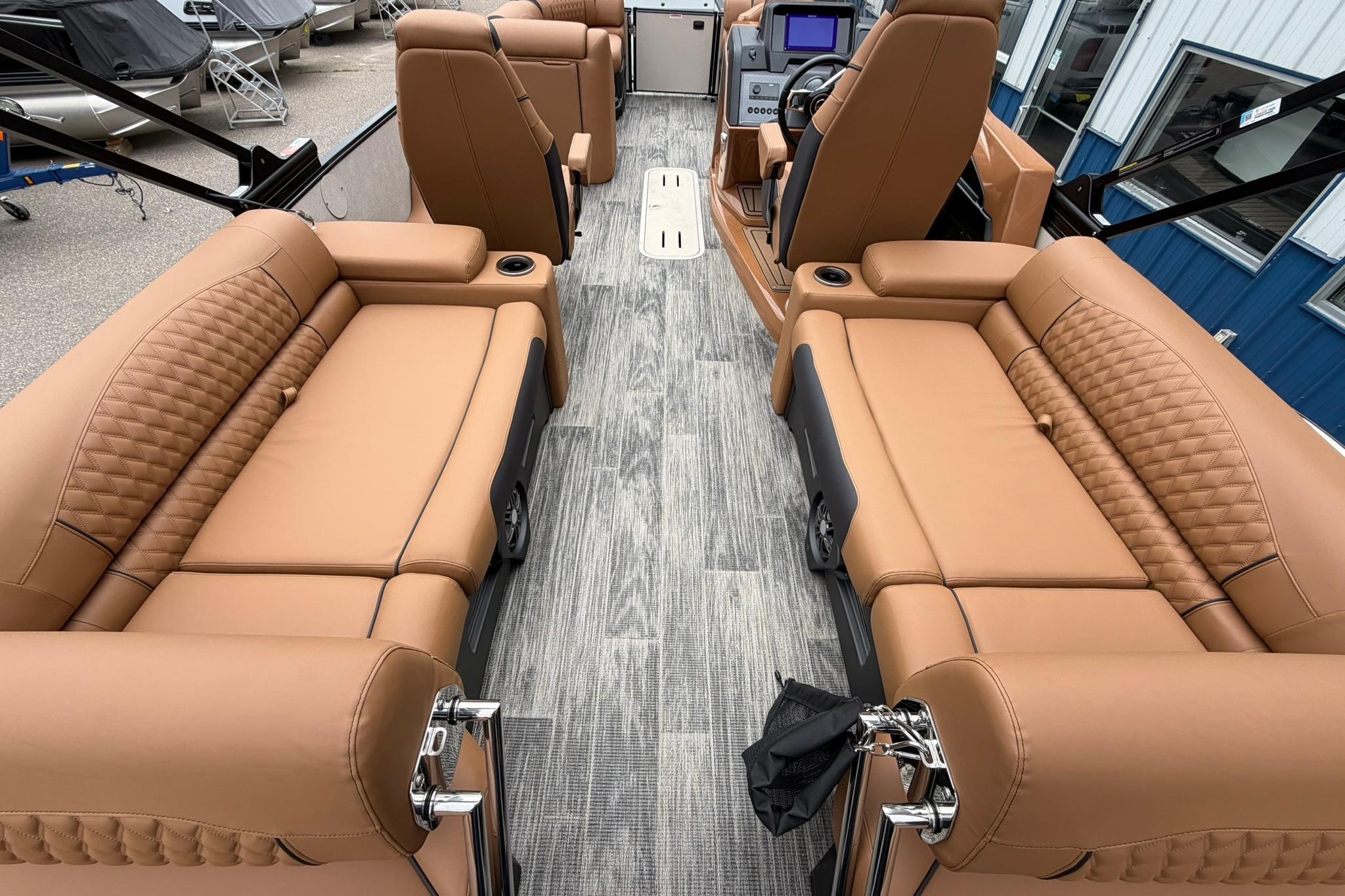 Luxurious interior of 2026 Avalon Catalina Quad Lounge Shift boat with tan seating and modern dashboard.